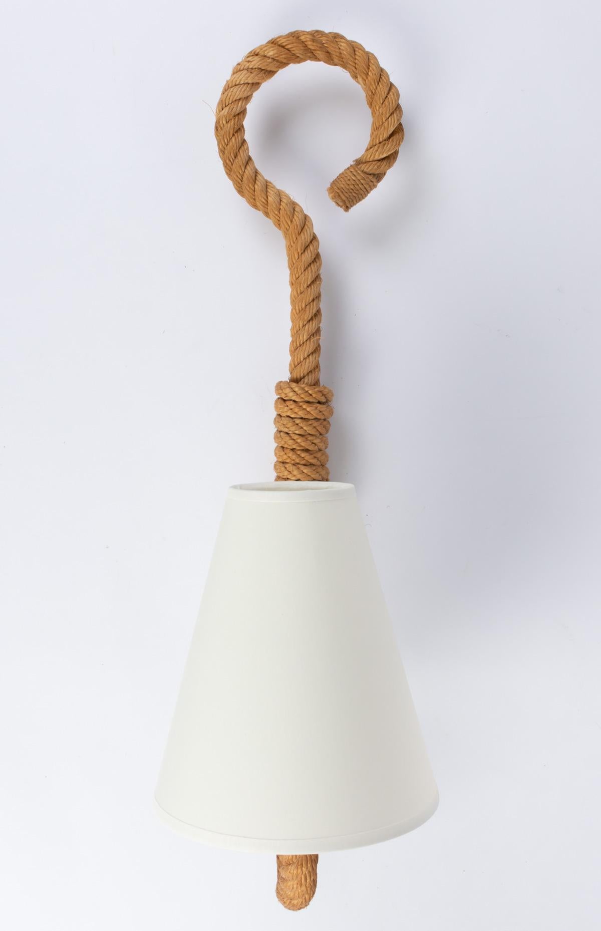 Each wall light consists of a weaved rope arm. They end with a loop open on their upper parts. The curved arm supports an off-white cotton lampshade, identical to the originals. One bulb per wall light.

Adrien Audoux and Frida Minet are known for