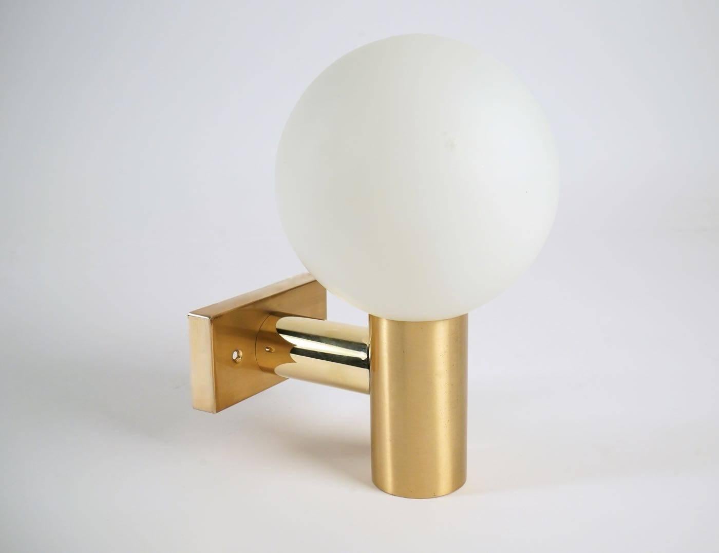 1950s pair
The sconces structure is made of gilded brass and supports a large ball of white satin glass globe as shade.
One bulb per sconces.