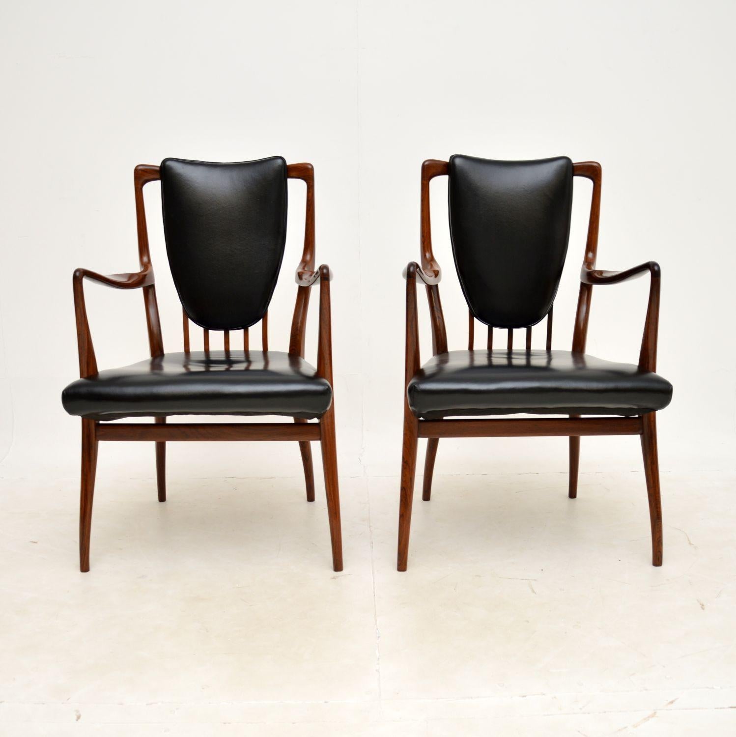 An absolutely stunning and very rare pair of carver chairs by Andrew Milne. They were designed in the 1940’s for Heal’s, this pair dates from the 1950’s.

They have a spectacular design, and look beautiful from every angle. The quality is amazing,
