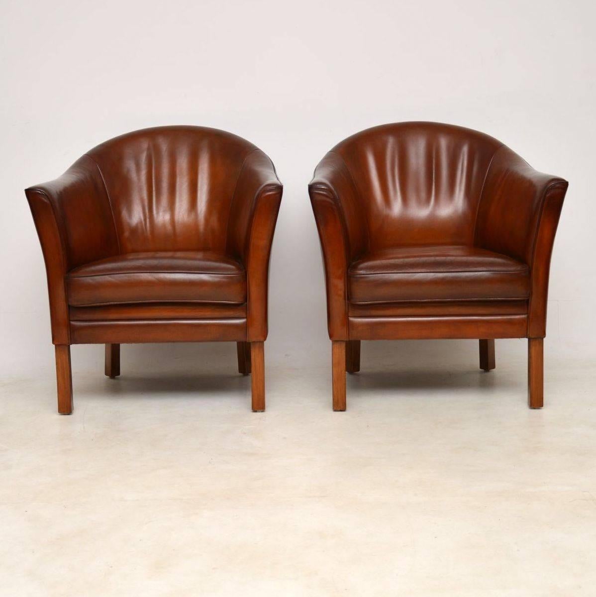 A stunning pair of Danish vintage leather armchairs, these were made by Mogens Hanen, they date from the 1950s-1960s. They are in excellent condition for their age, we have had the original leather hand colored to a beautiful chestnut brown color.