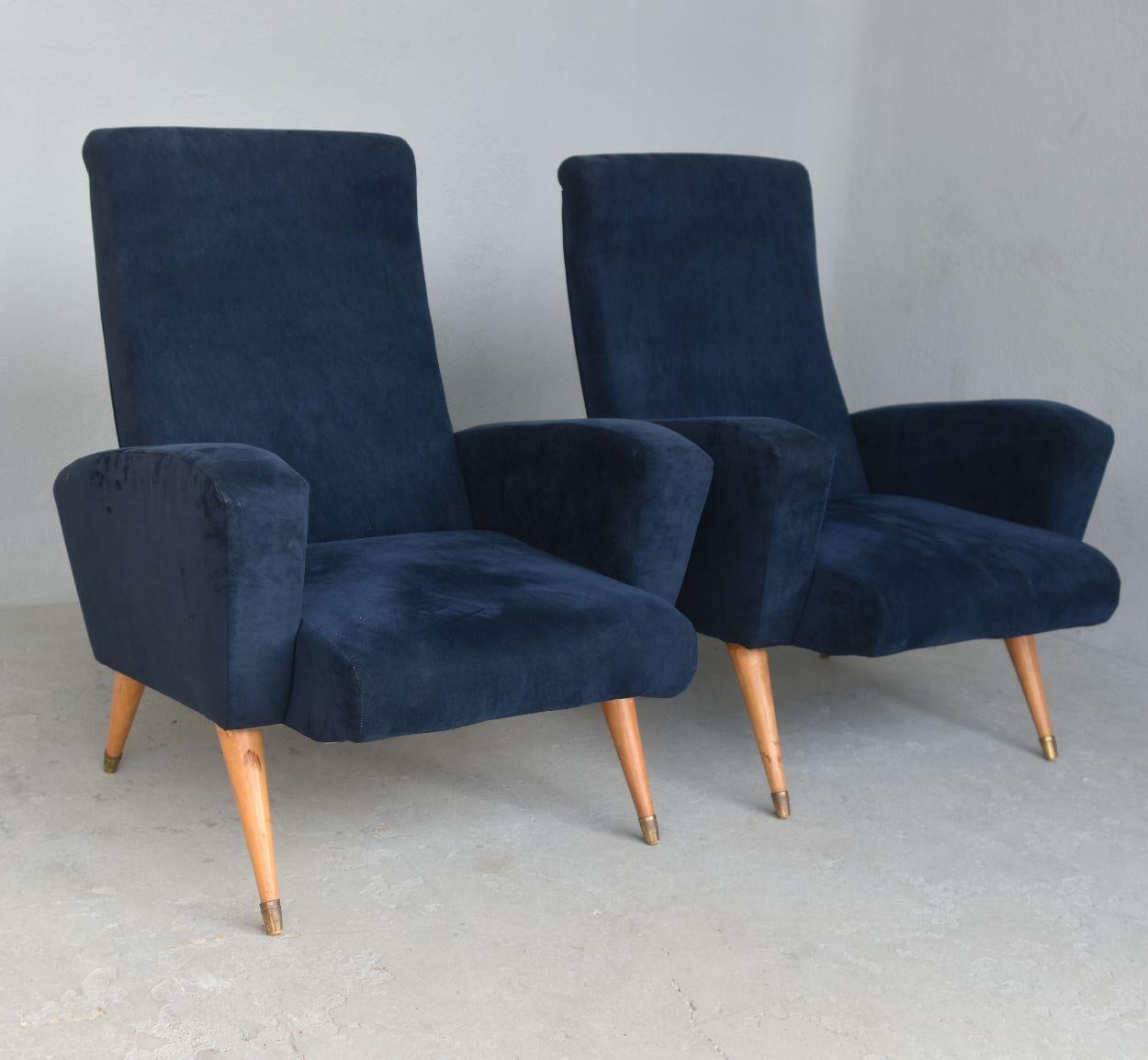 Pair of Italian 1950s design armchairs covered with new blue suede (imitation), very comfortable. Maple foot and brass clogs.