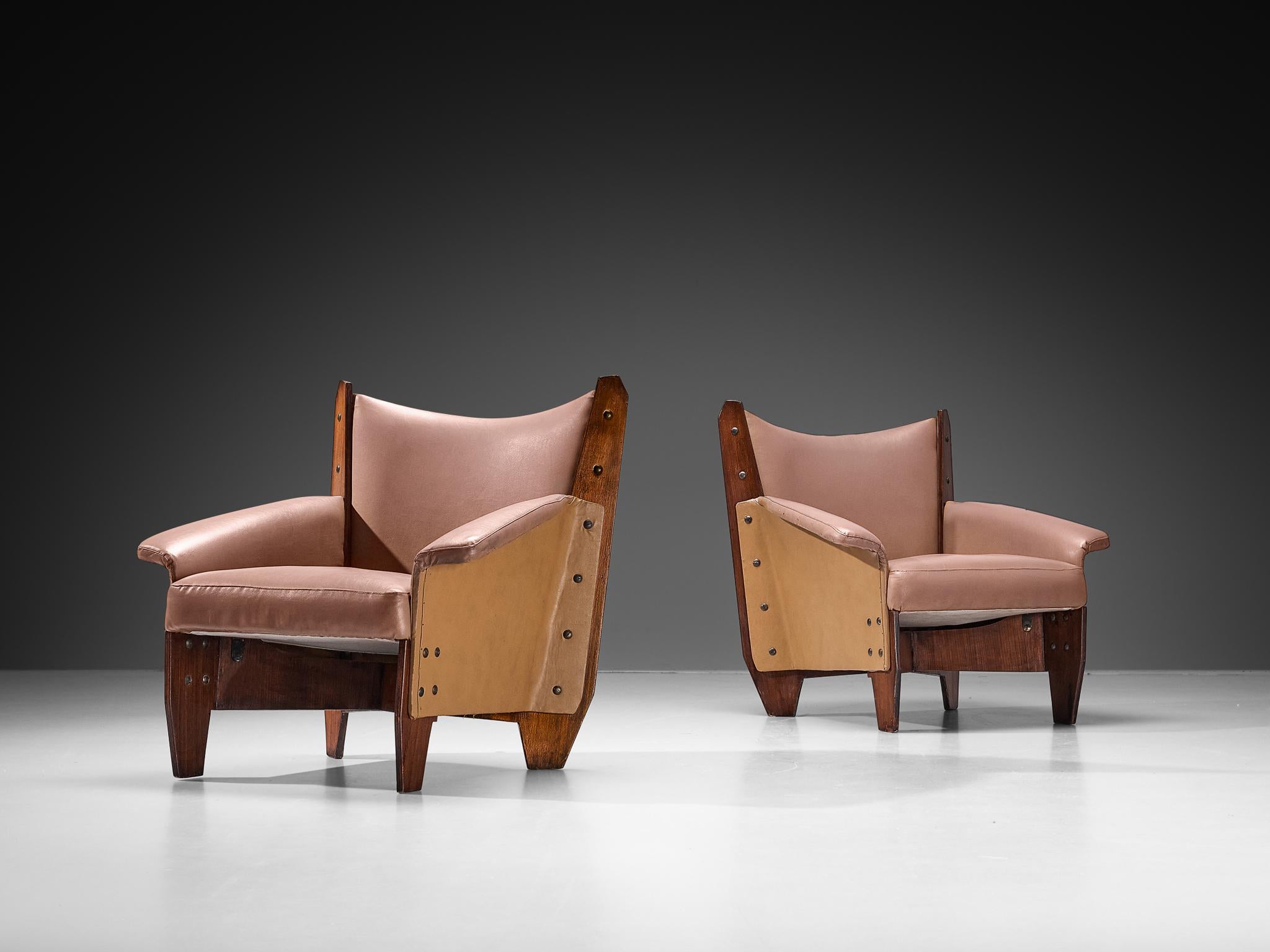 Pair of armchairs, mahogany plywood, faux leather, metal, Italy, 1950s

These easy chairs embody an exquisite form made possible by the inherent quality of the plywood, resulting in sharp, sleek lines and solid geometry. The crescent-shaped backrest