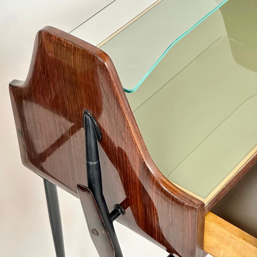 Stylish and cosy pair of night stands with a light green opaline glass top (at 48 H cm.) and one drawer each. A second transparent glass support surface is resting above the opaline glass tops. Very interesting black painted iron leg work with
