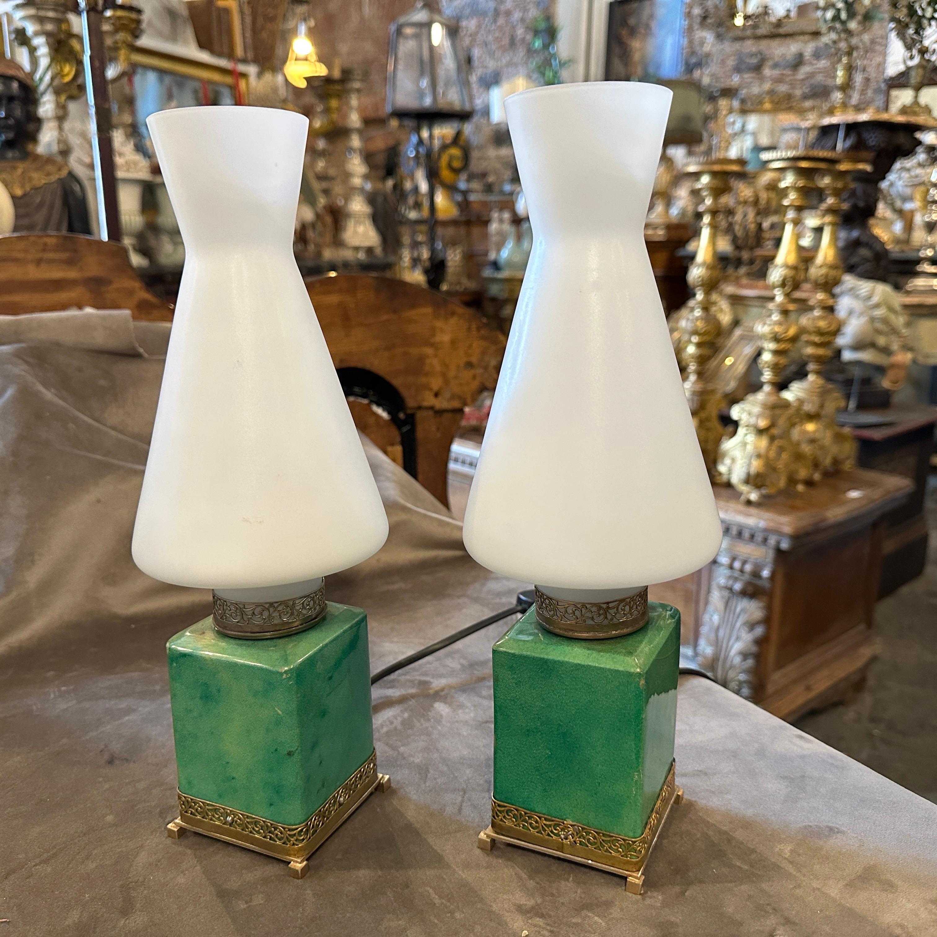 A set of Mid-Century Modern bed lamps designed by Aldo Tura and manufactured by Tura Creazioni in Milano in the Fifties. They have small signs of use and age visible on the photos, they are in working order and labeled on the bottom. The Bed Lamps