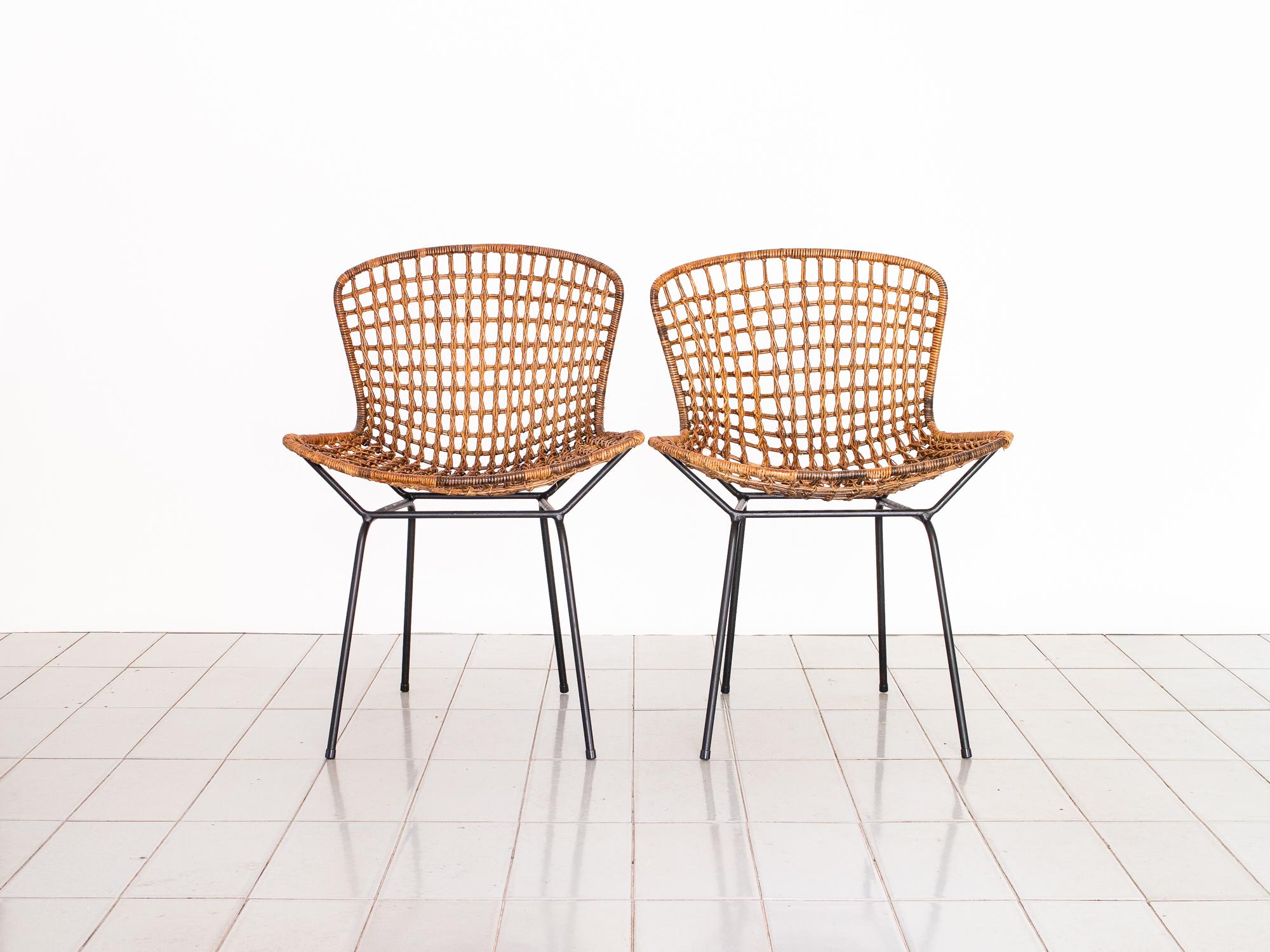 Beautiful, ingenious Brazilian version of a Bertoia chair, designed by one of our greatest designers, Carlo Hauner. Produced by Móveis Artesanal in the early 1950s.

Wrought iron structure sustains the reed basket, creating the impression that