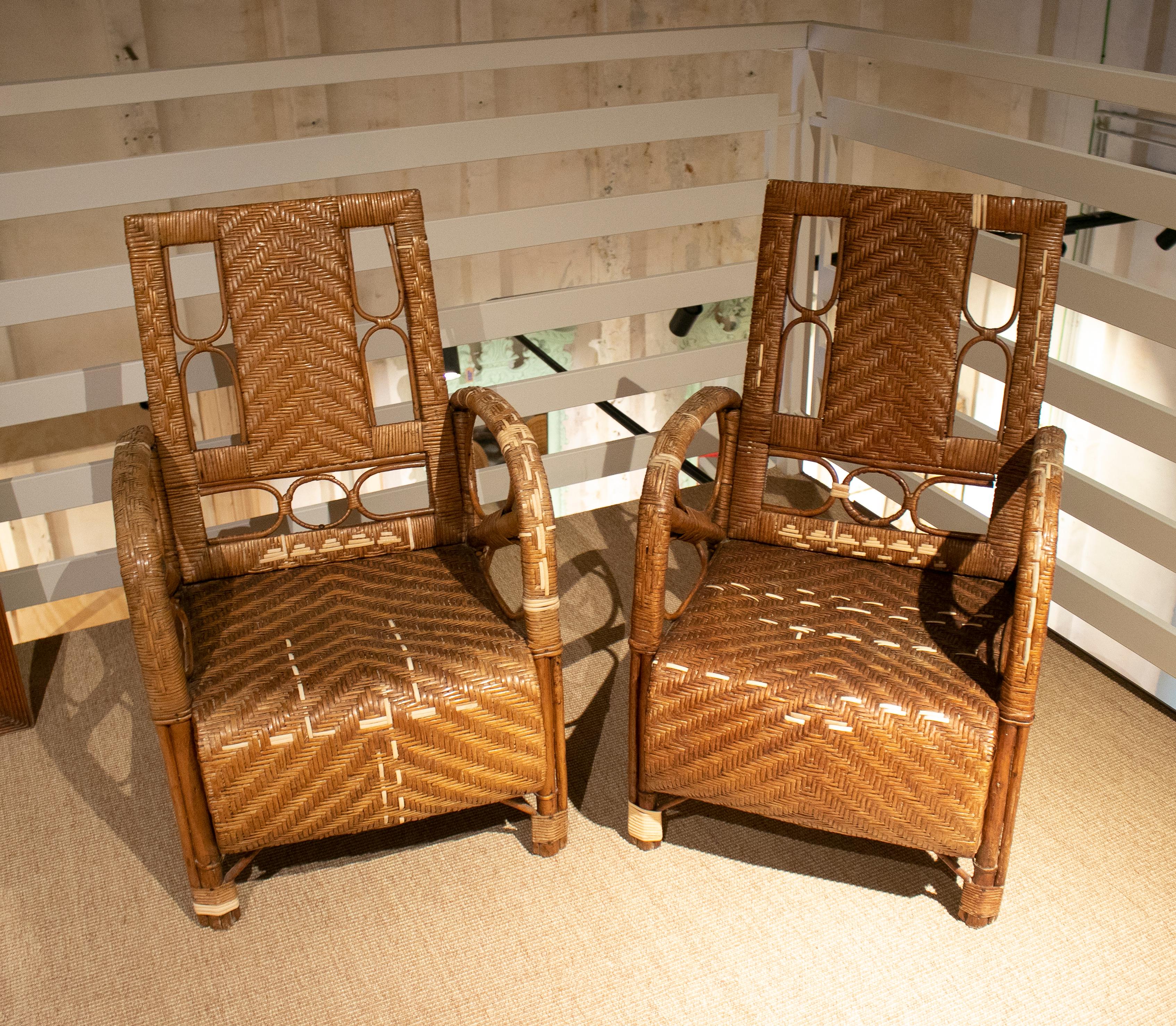 Vintage 1950s pair of Spanish hand woven wicker armchairs.