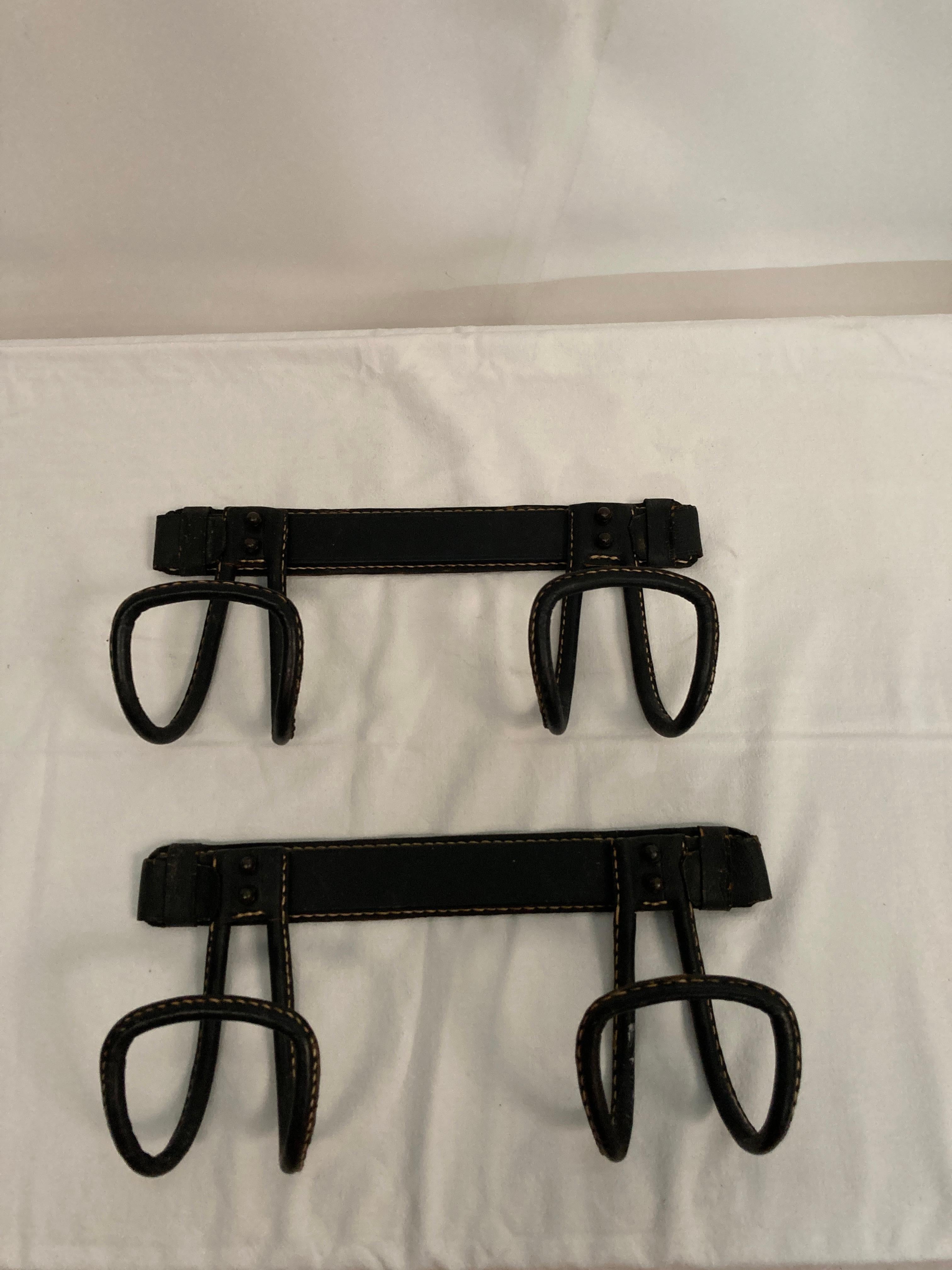 1950's Stitched leather coat racks by Jacques Adnet
Sold as a pair