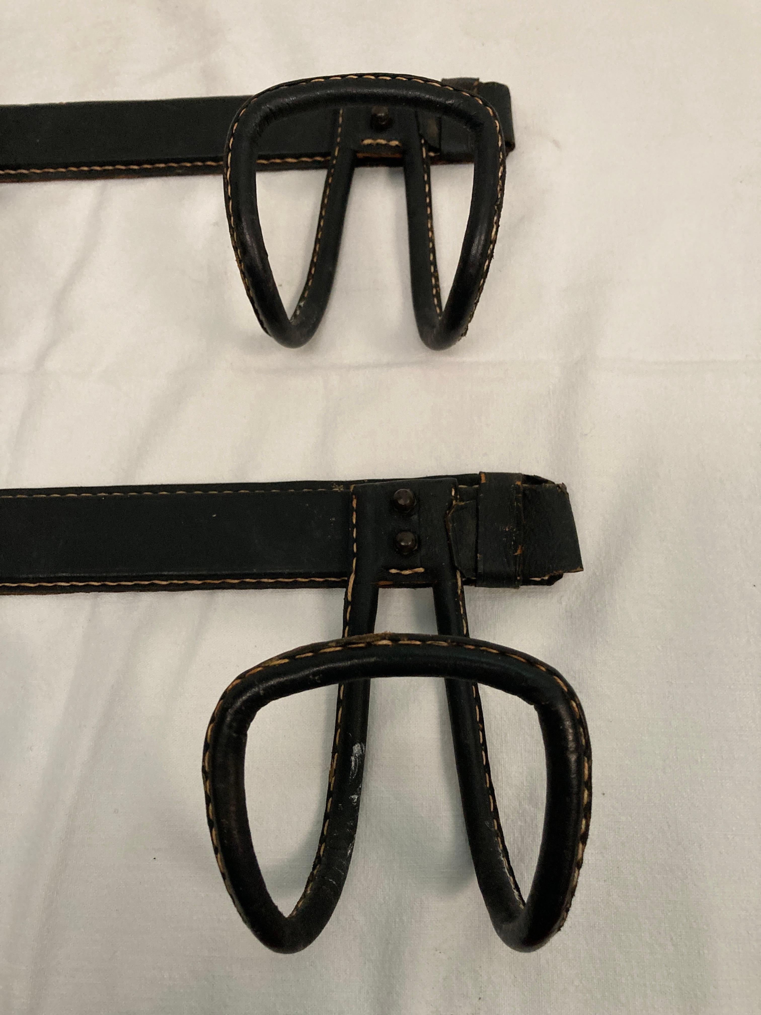 French 1950's Pair of Stitched leather coat rack by Jacques Adnet For Sale