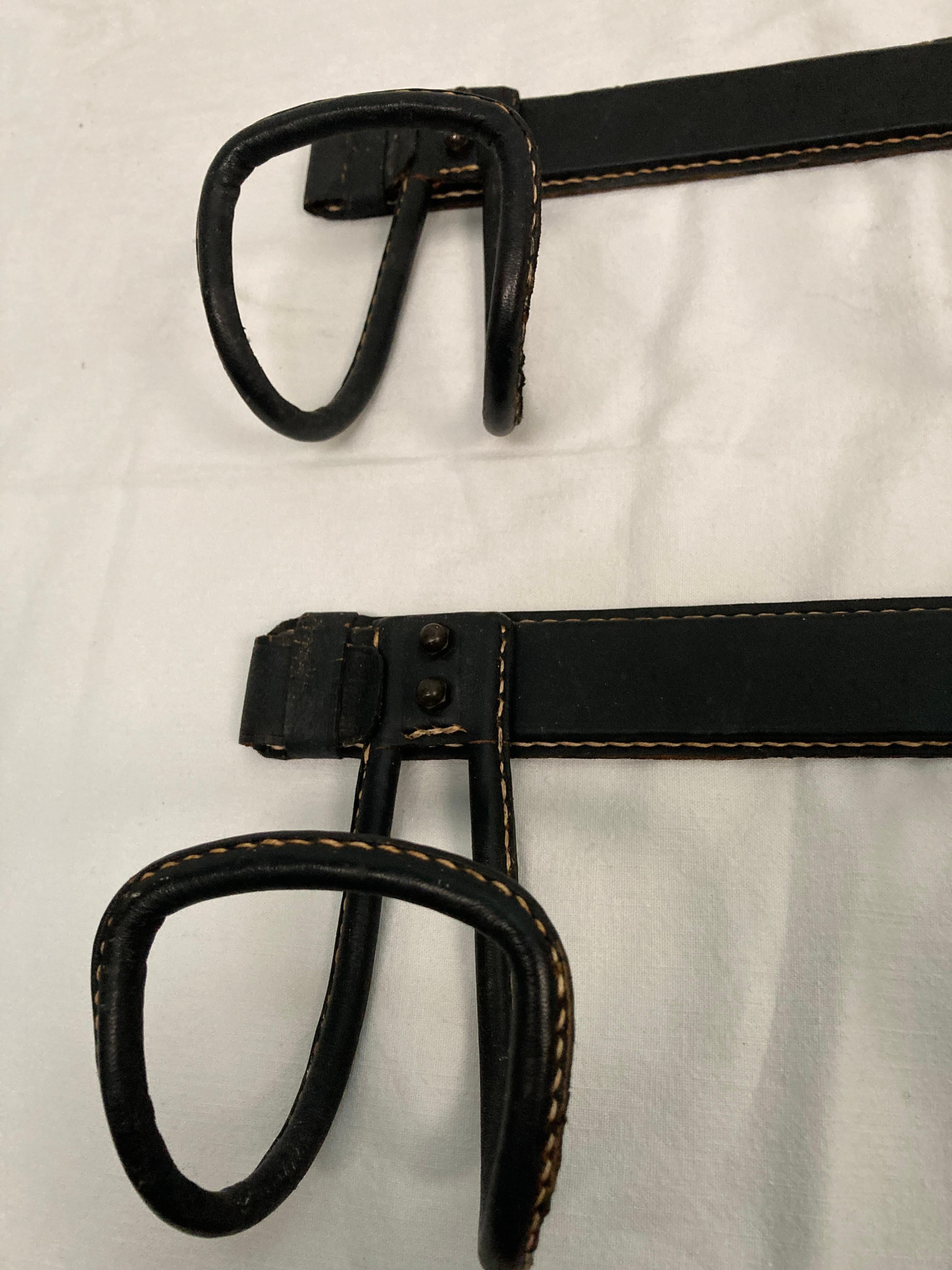 1950's Pair of Stitched leather coat rack by Jacques Adnet In Fair Condition For Sale In Bois-Colombes, FR