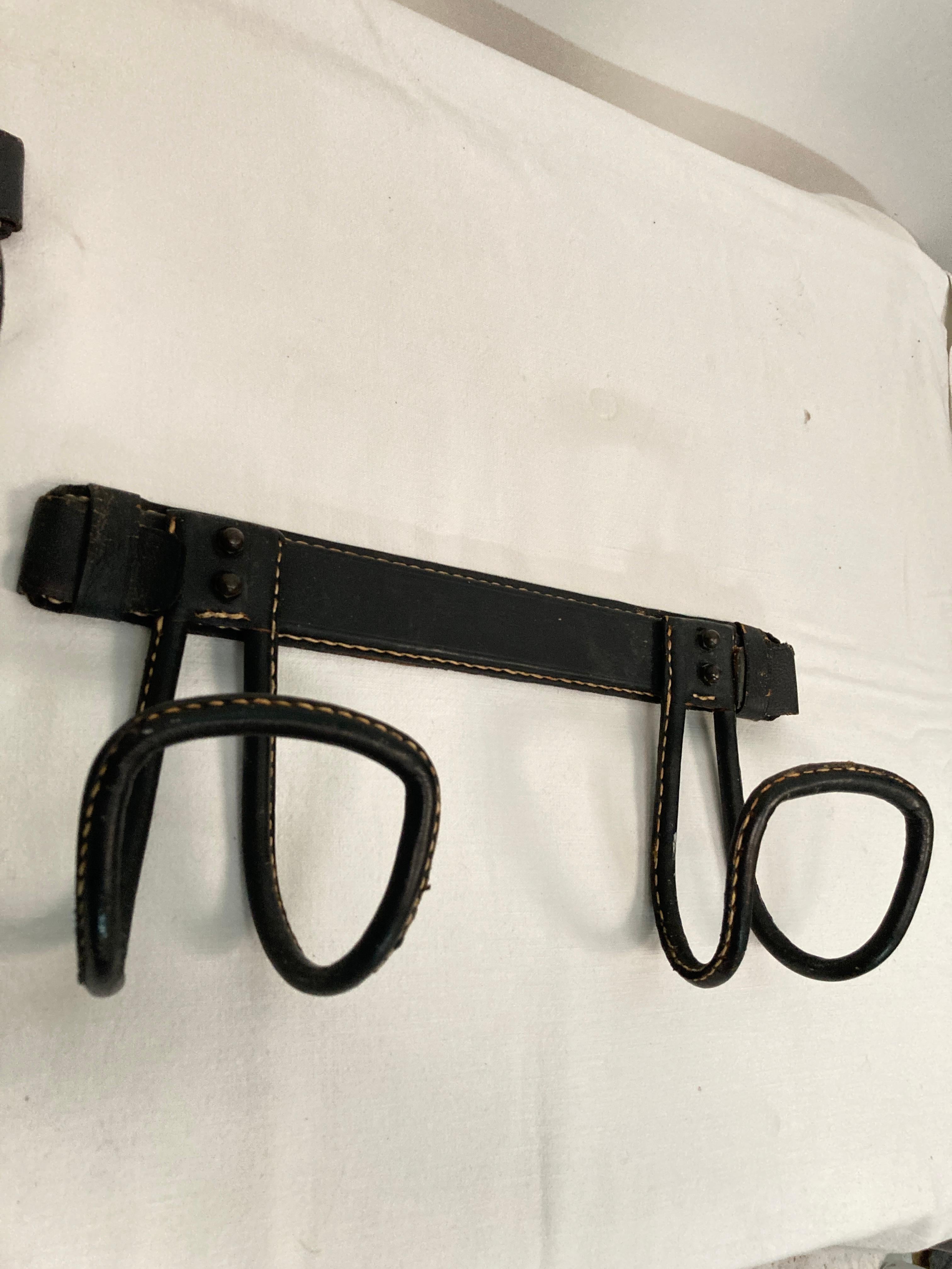 Mid-20th Century 1950's Pair of Stitched leather coat rack by Jacques Adnet For Sale