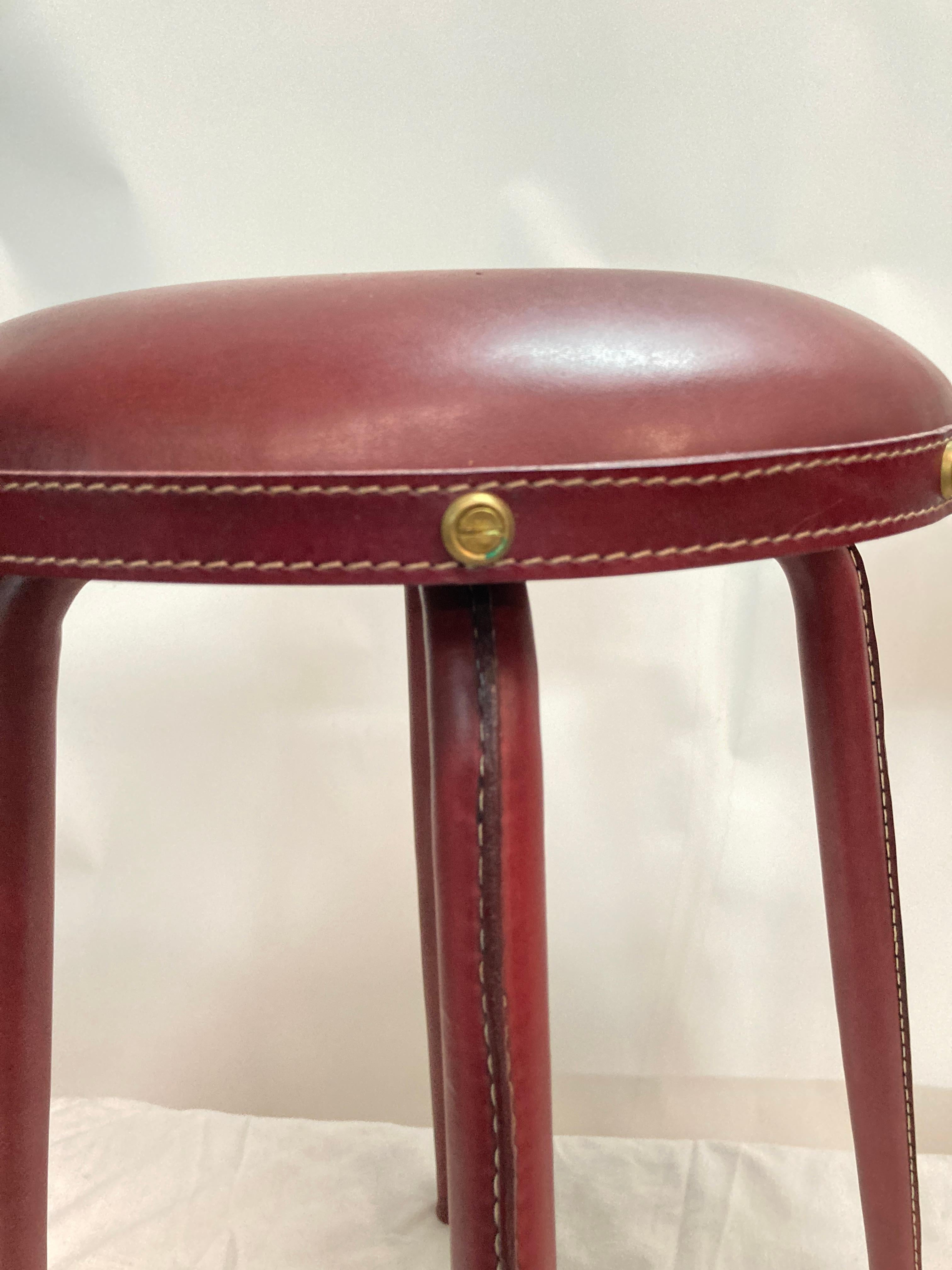 French 1950's pair of stitched leather stools by Jacques Adnet For Sale