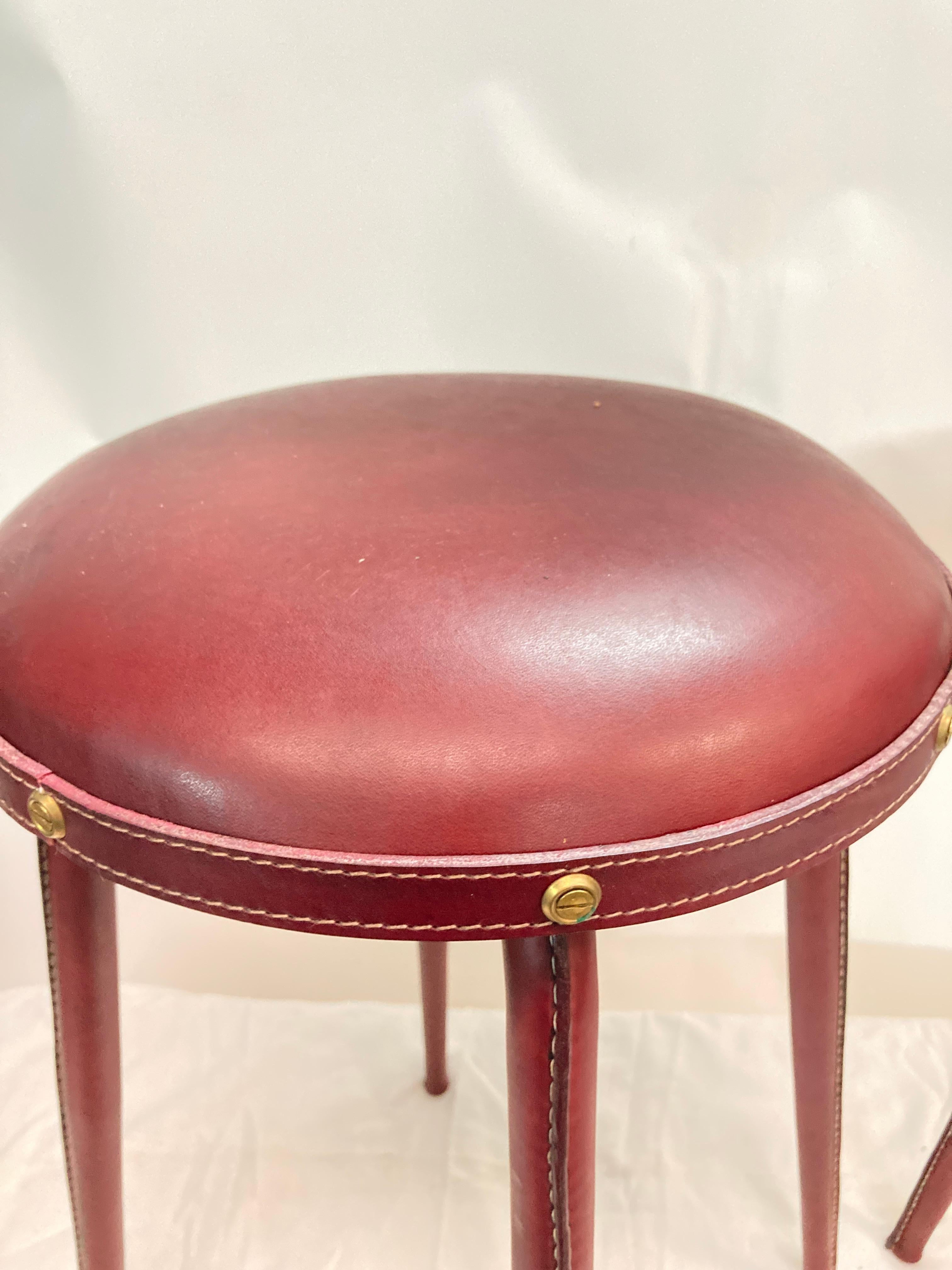 Leather 1950's pair of stitched leather stools by Jacques Adnet For Sale