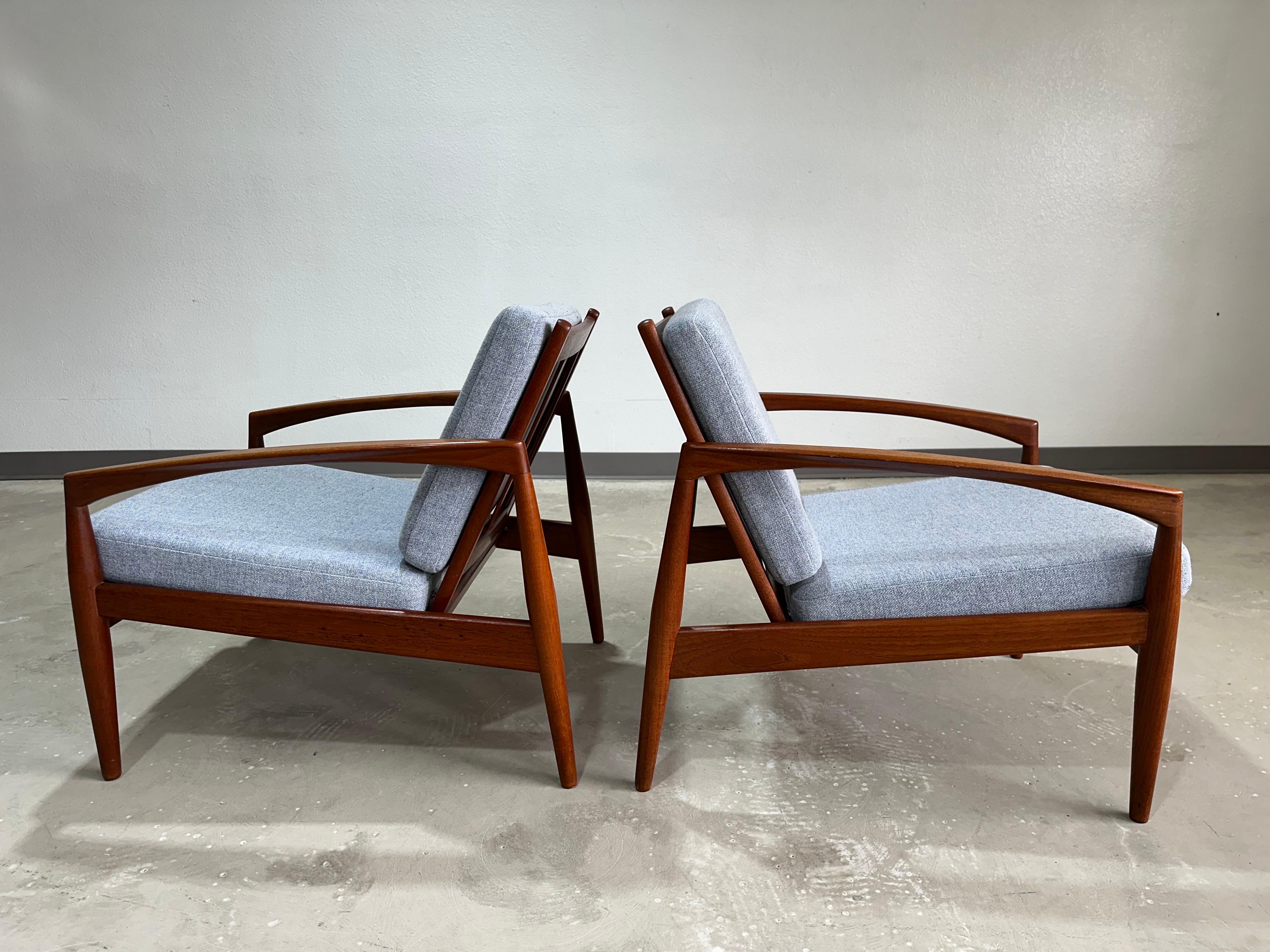 Mid Century Modern Pair of Danish Teak Model 121 Paper Knife Chairs designed by Kai Kristiansen for Magnus Olesen in 1956. Untagged but well documented design/chairs.

Previously restored frames and newer cushions within past 5 years. Upholstery