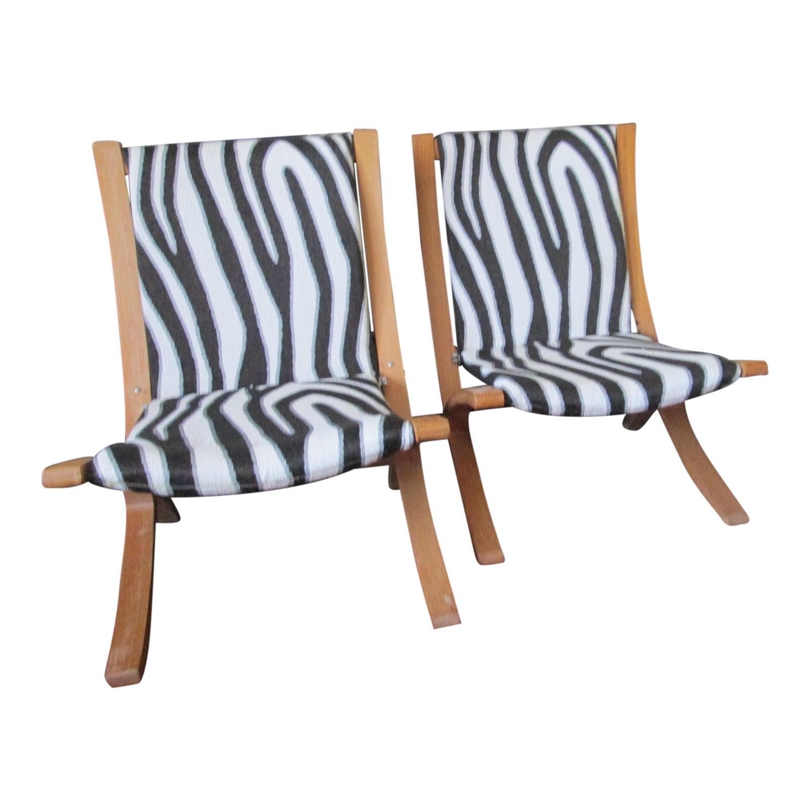 Scissor lounge chairs become even more irresistible re-imagined in a zebra pattern that is chic and durable. This is the most comfortable chair to while away time, read and relax. They are sturdy and in very good vintage condition. 
The chairs are