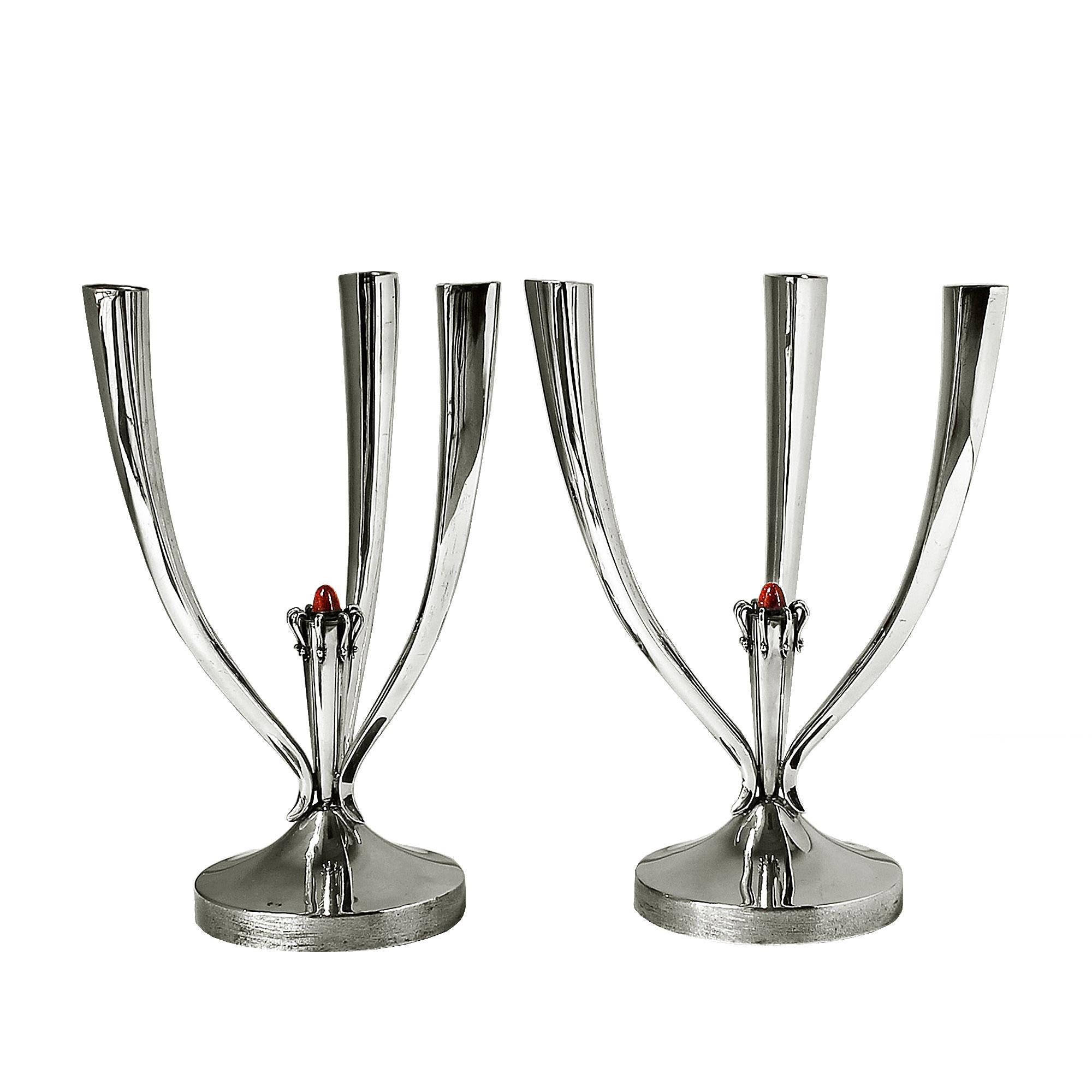 Pair of candelabras, sterling silver, three branches, central red enameled cabochon, weight on base.
Stamps: Star and illegible, M on base.
Star stamp is for sterling silver in Spain since 1934.
Weight: 547 grms each
Spain, Barcelona, circa 1950.