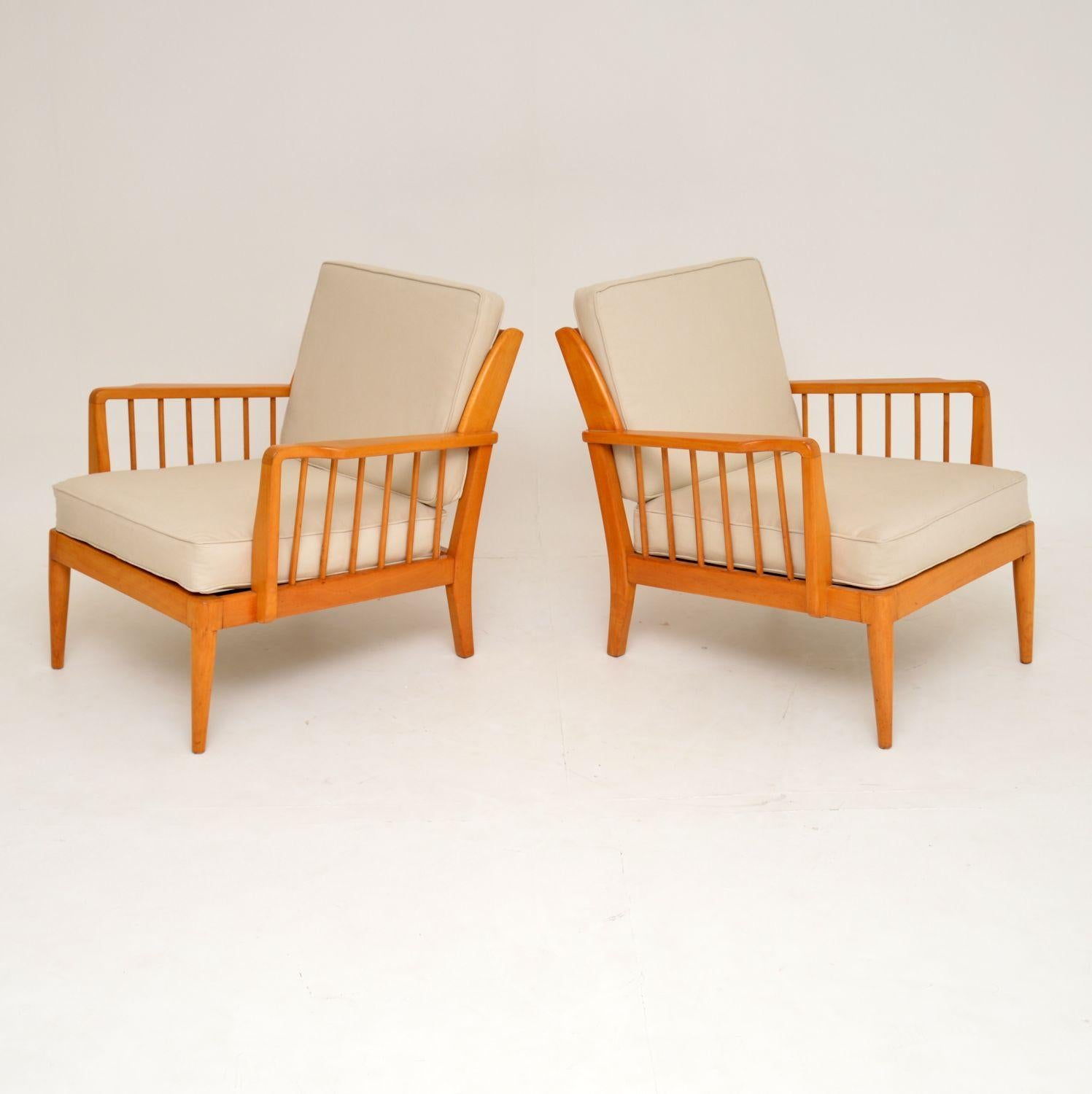 A stylish and very comfortable pair of vintage armchairs. These were made by George Stone of High Wycombe, they date from the 1950s-1960s. The condition is superb throughout, they have been fully restored. The frames have been stripped and