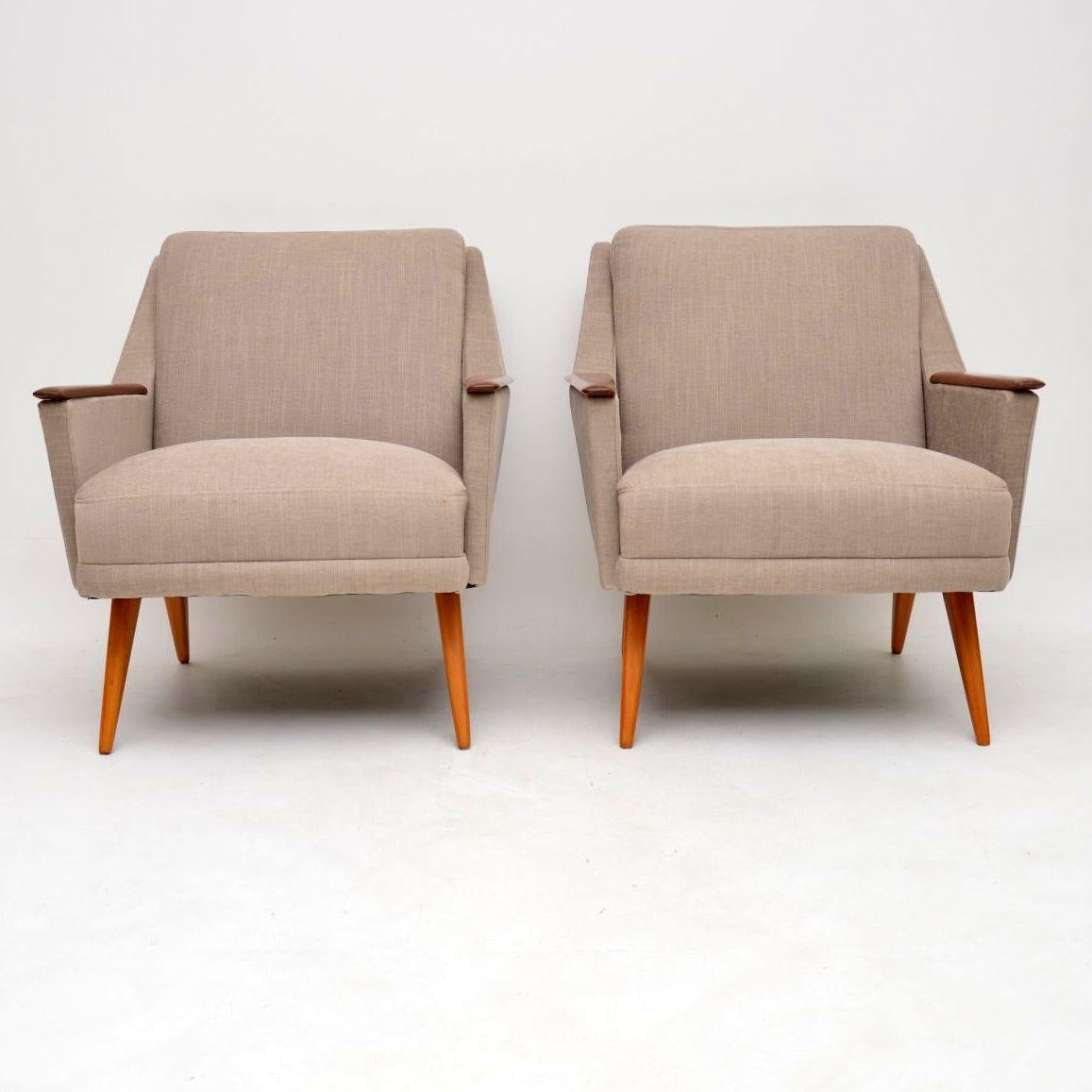 A stunning and very comfortable pair of vintage armchairs, these were made in Denmark and they date from the 1950s-1960s. They have a stylish design, and are very well built for maximum comfort. We have had the legs and arms stripped and re-polished