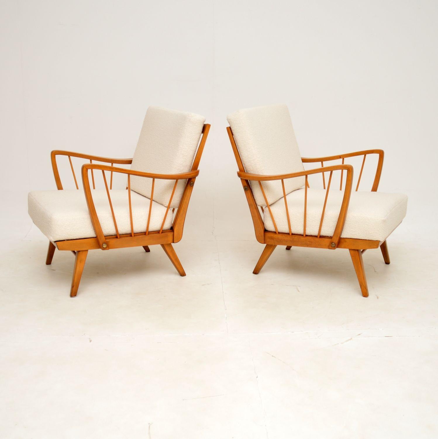 A stylish and very well made pair of vintage French open armchairs in solid birch. They were recently imported from France, and they date from the 1950s-196s.

They are a lovely size, and are very comfortable to relax in. The solid birch frames