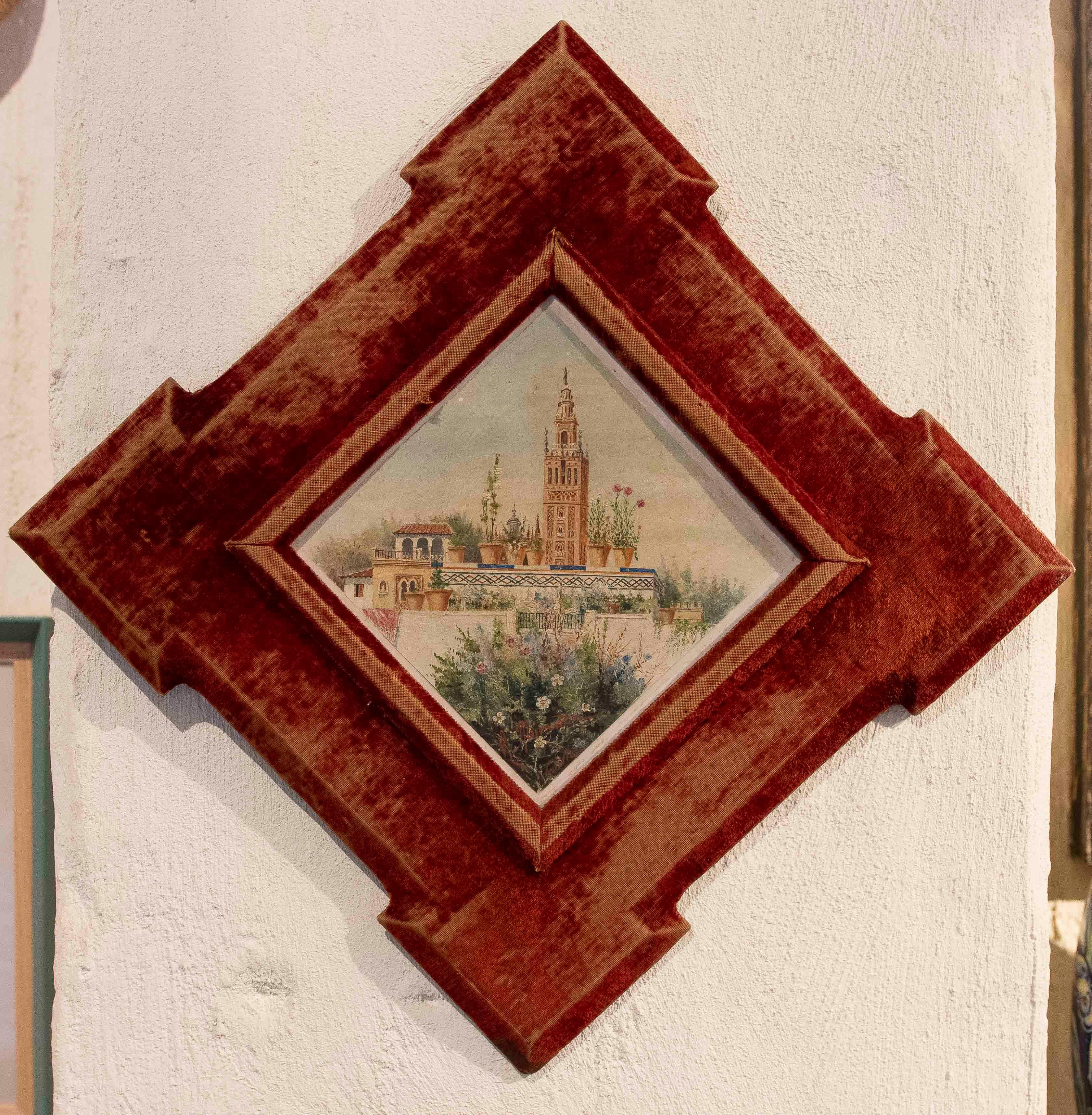 Une paire élégante d'aquarelles de petit format, chacune encadrée dans un cadre en velours rouge distinctif avec un motif géométrique en forme de losange. Les scènes représentent deux vues architecturales traditionnelles : une vue panoramique d'une