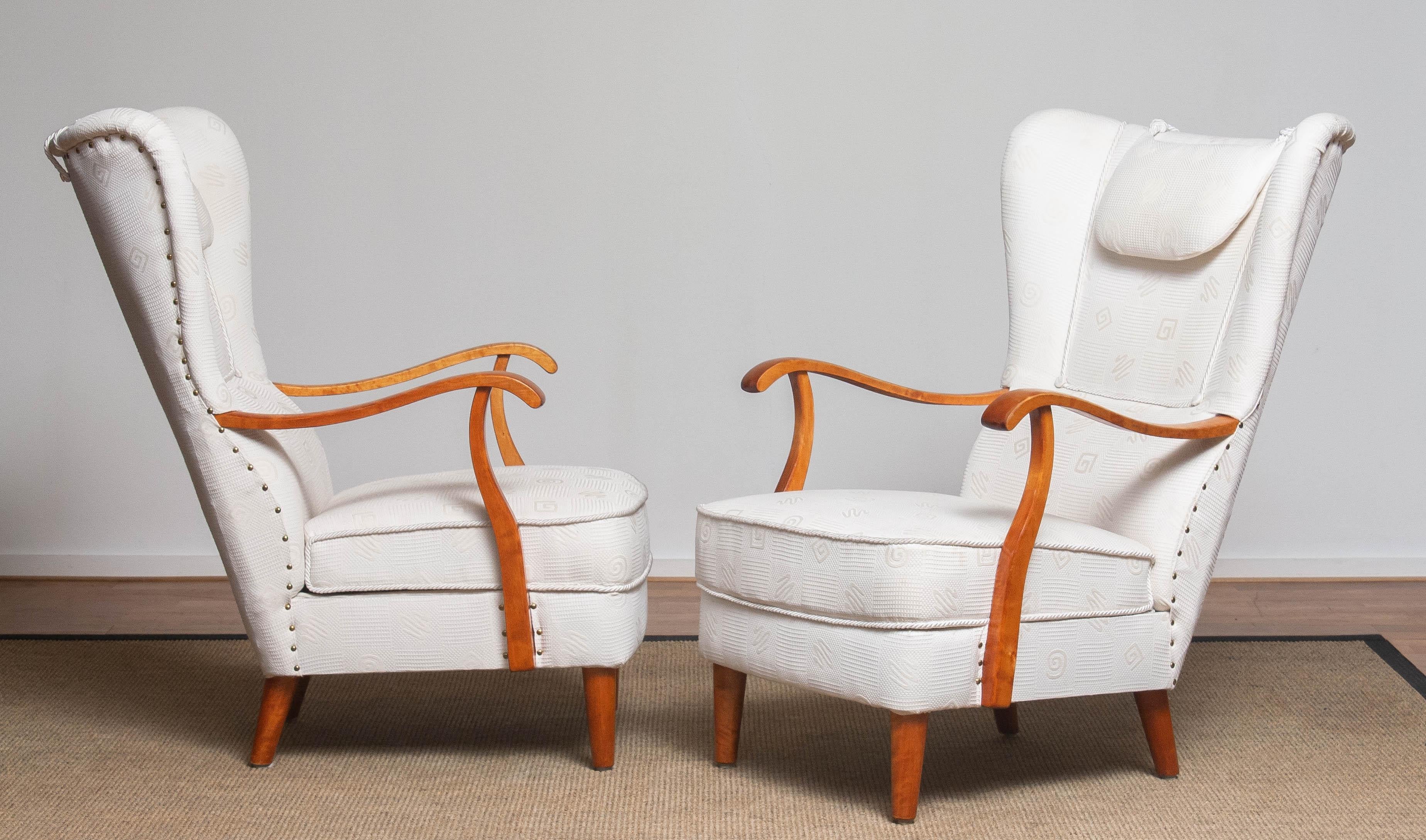 Beautiful and extremely rare set of two gentlemen wingback chairs made in the 1950's by Wilhelm Knoll for Knoll Malmö in Sweden. These chairs are in a later period (90's) reupholstered in a white jacquard fabric. Constructive the chairs are still