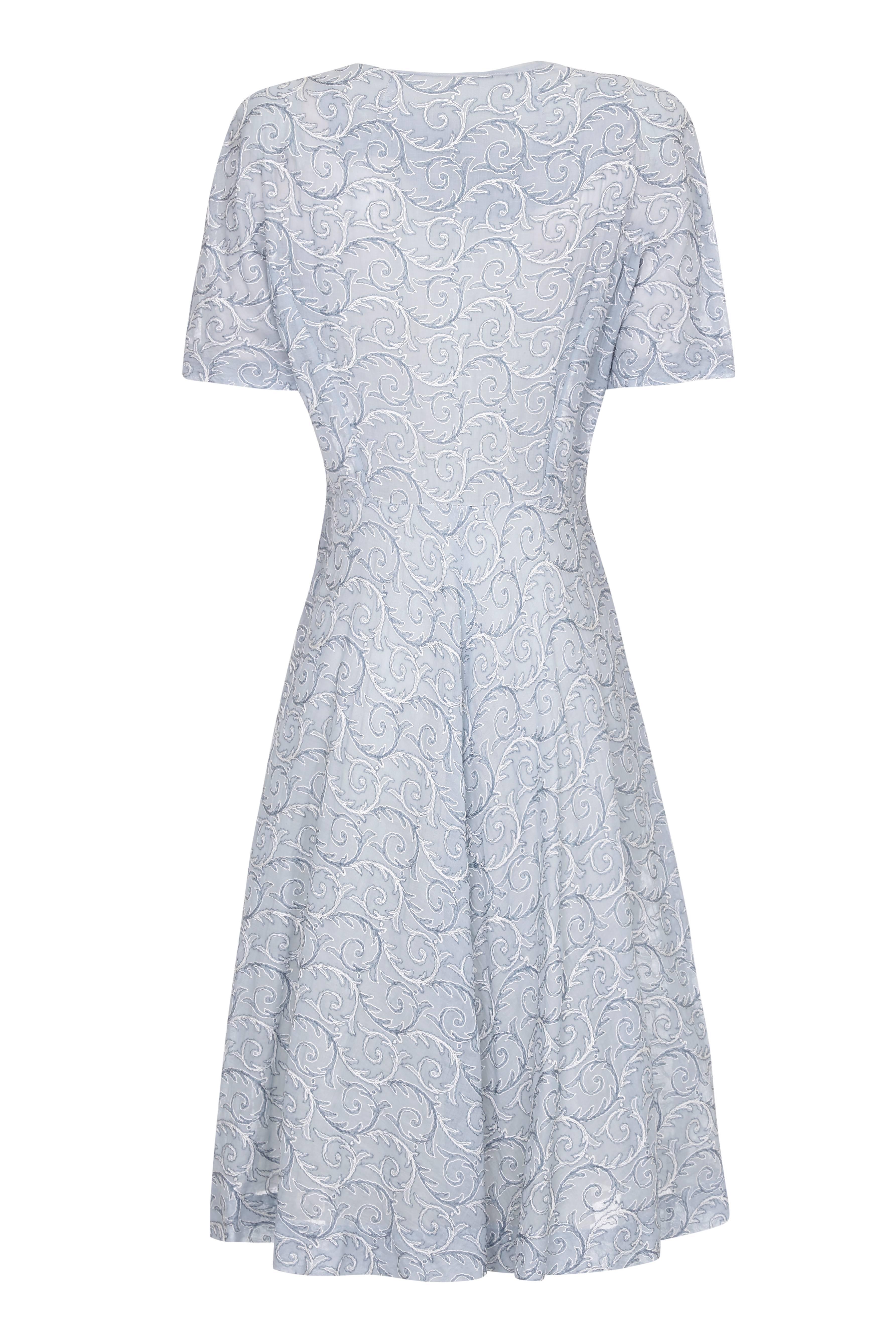 This lovely late 1950s /early 1960s light weight cotton dress in pale blue bears no makers labels but is a very wearable dress and is in excellent vintage condition. The fine cotton fabric is machine embroidered with a swirling fern design in a