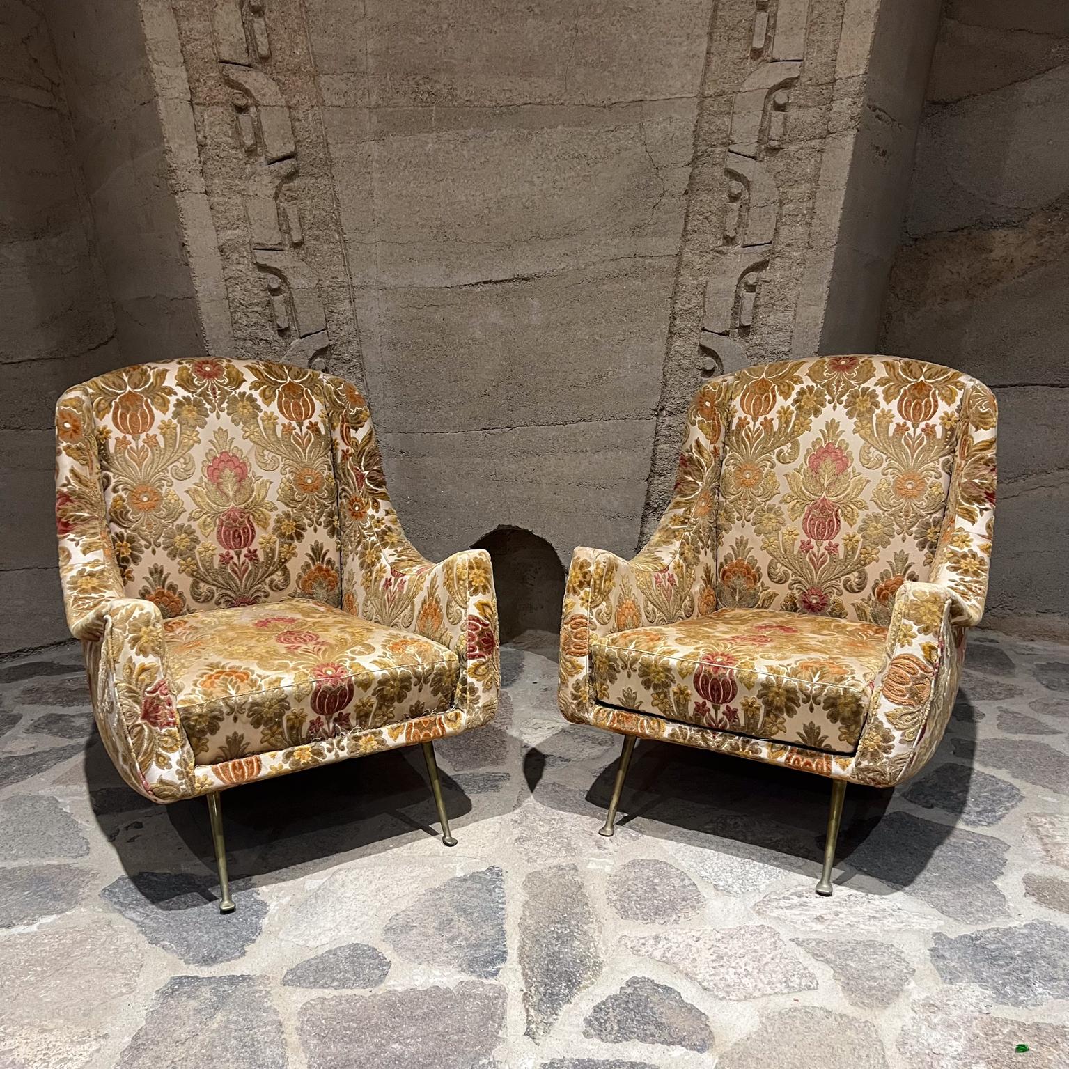 1950s Paolo Buffa attributed sexy lounge chairs made Italy.
selling as a pair
No label present, attributed Paolo Buffa. 
original floral pattern upholstery.
sculptural solid brass legs with vintage patina
31 h x 28 w x 30 d seat 14.25 h 15.5 h