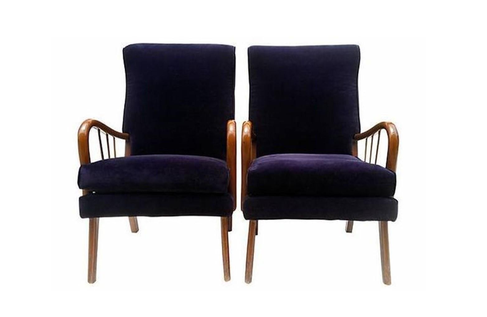 Stylish Paolo Buffa-style lounge chairs, circa 1950s. Wood frames having a slightly reclined back over a cushioned seat, spindle supports to the curved arms, rising on tapered legs. Original eggplant upholstery give these chairs a modern but