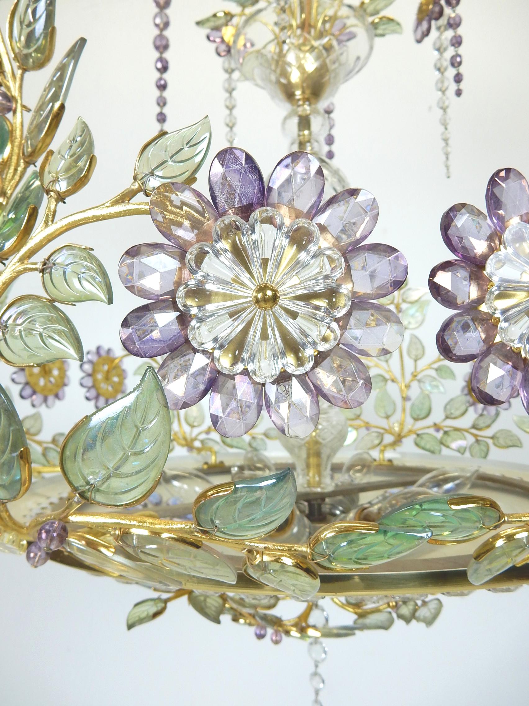 Incredibly beautiful floral crystal and brass chandelier by French lighting design firm Maison Baguès, circa 1950s.
Gorgeous violet, pale green and clear glass on gilded gold stems with a brass shade and ceiling cap.
Requires six standard light