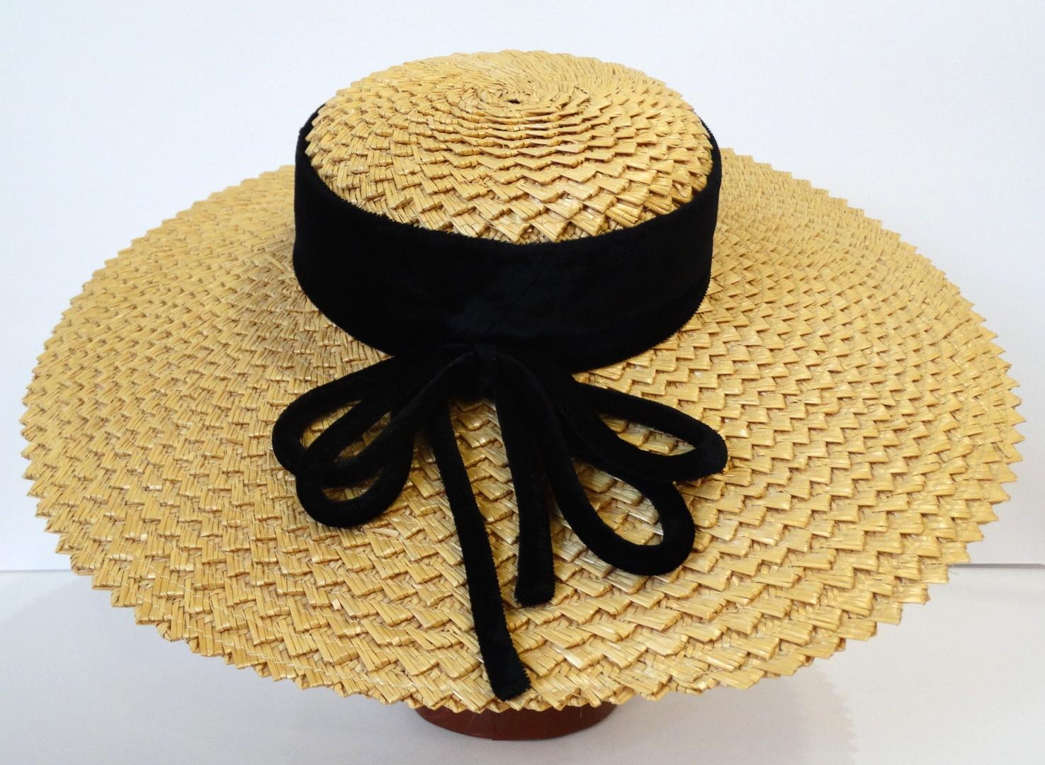 The most romantic little boater hat to satisfy all your Parisian dreams! Made of a classic woven yellow straw with a thick black band around the base of the rim. Playful multi-strand bow on the side. Pairs perfectly with all your favorite sundresses