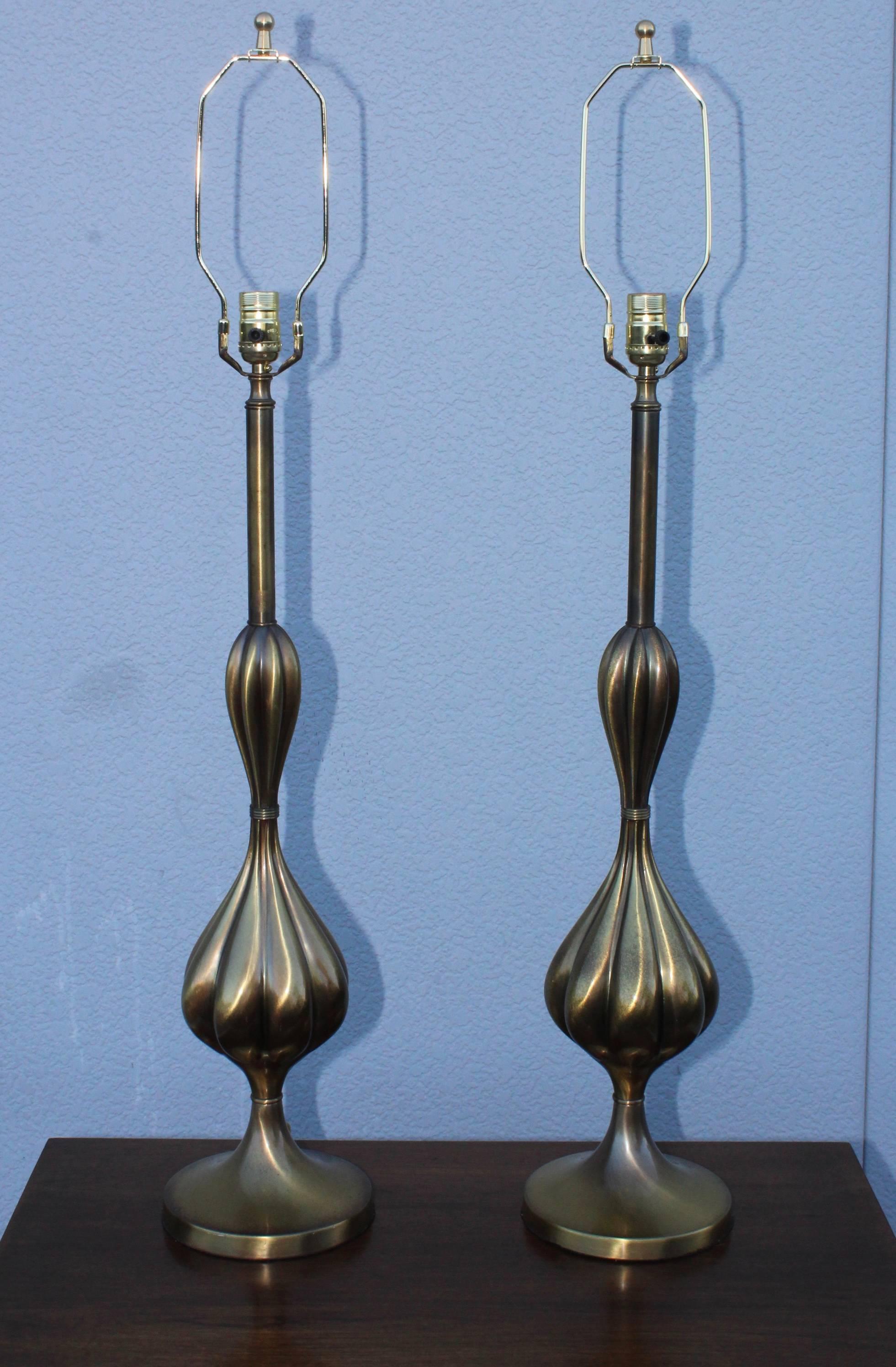 1950s patinated brass tall table lamps by Stiffel.

Height to light socket 31.5.