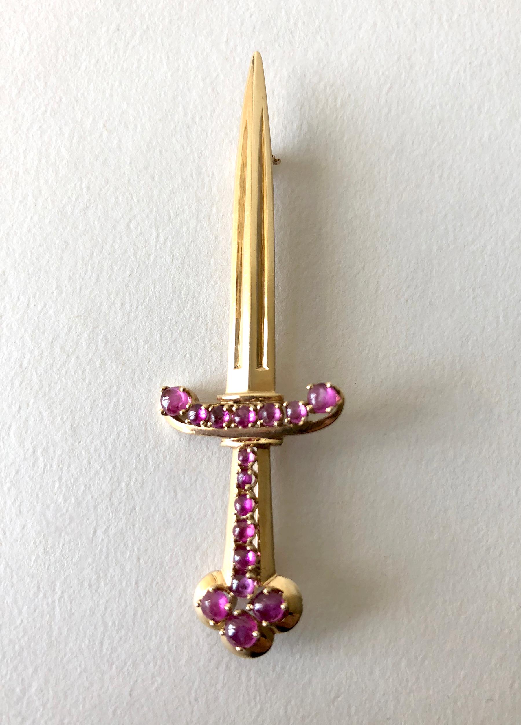 1950's 14K rose gold sword pin with ruby encrusted handle created by Paul Lackritz Jewelers of Beverly Hills.  Brooch measures 2 3/4