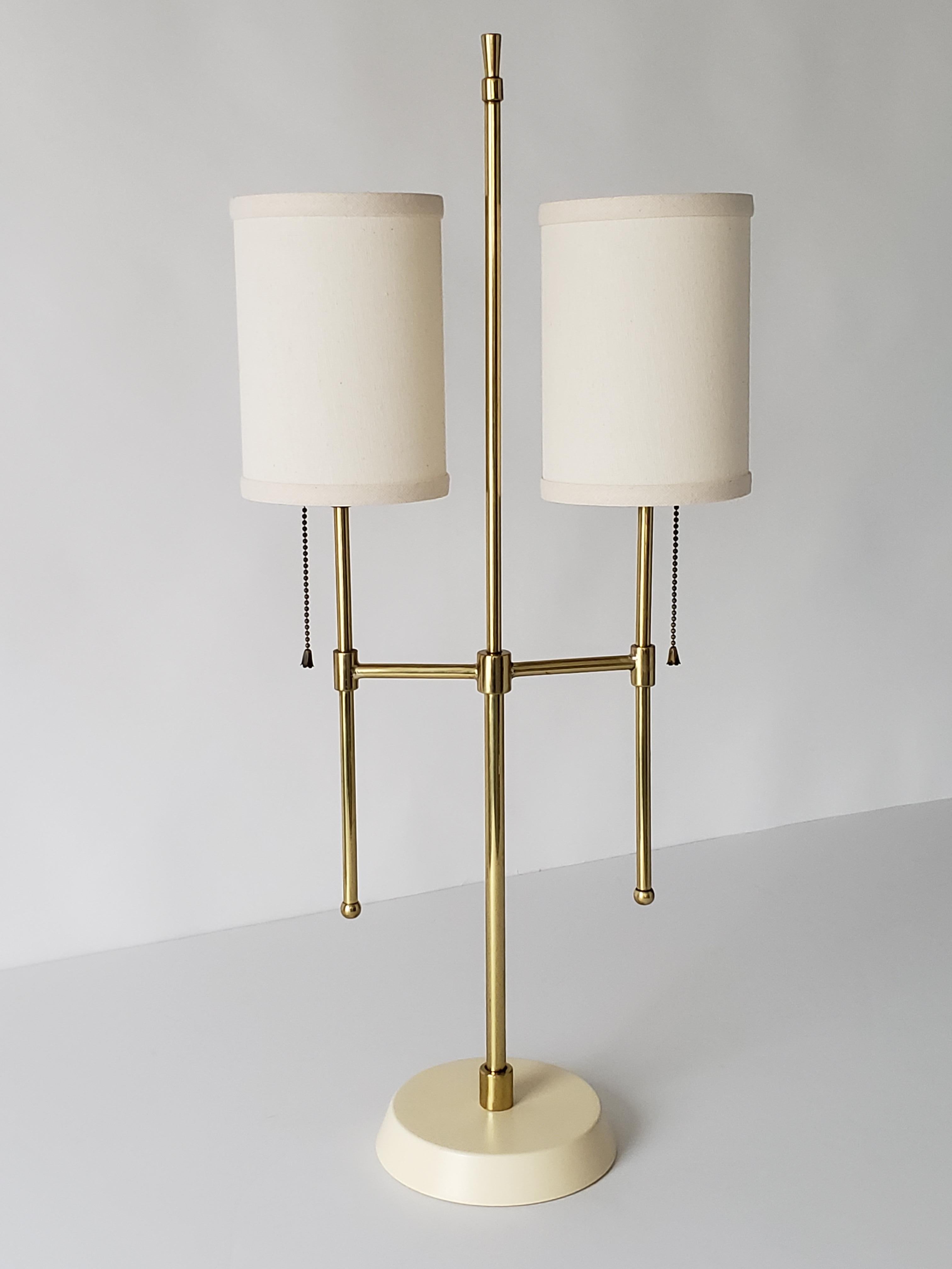 Well-made brass table lamp on enameled base. 

The new shade provides a nice warm glow when lighted. They measure 7 in. x 15 in.
 
On\Off pull chain on original socket with E26 base rated at 60 watts.