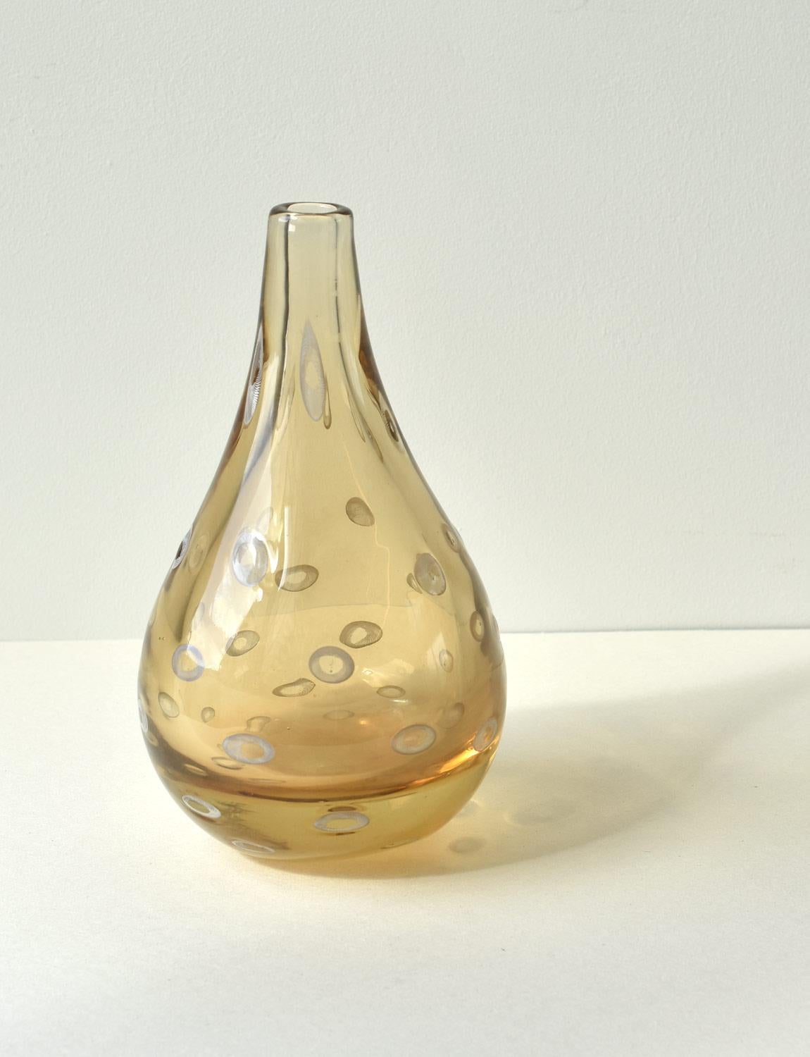This exceptional Murano Glass vase was made in Venice by Pauly & Co in the 1950s. This vase is an exquisite peach golden colour and is decorated with white Murrine. Murrine are patterns or images made in glass canes that are revealed when the cane