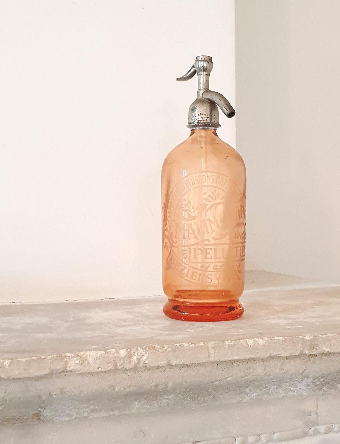 This 1950s rare peach soda siphon was found in Arezzo but is infact French from a bar in Bezier. This beautiful decorative piece was originally used in an French bar to create soda water. The colour of the glass is outstanding and the piece is in
