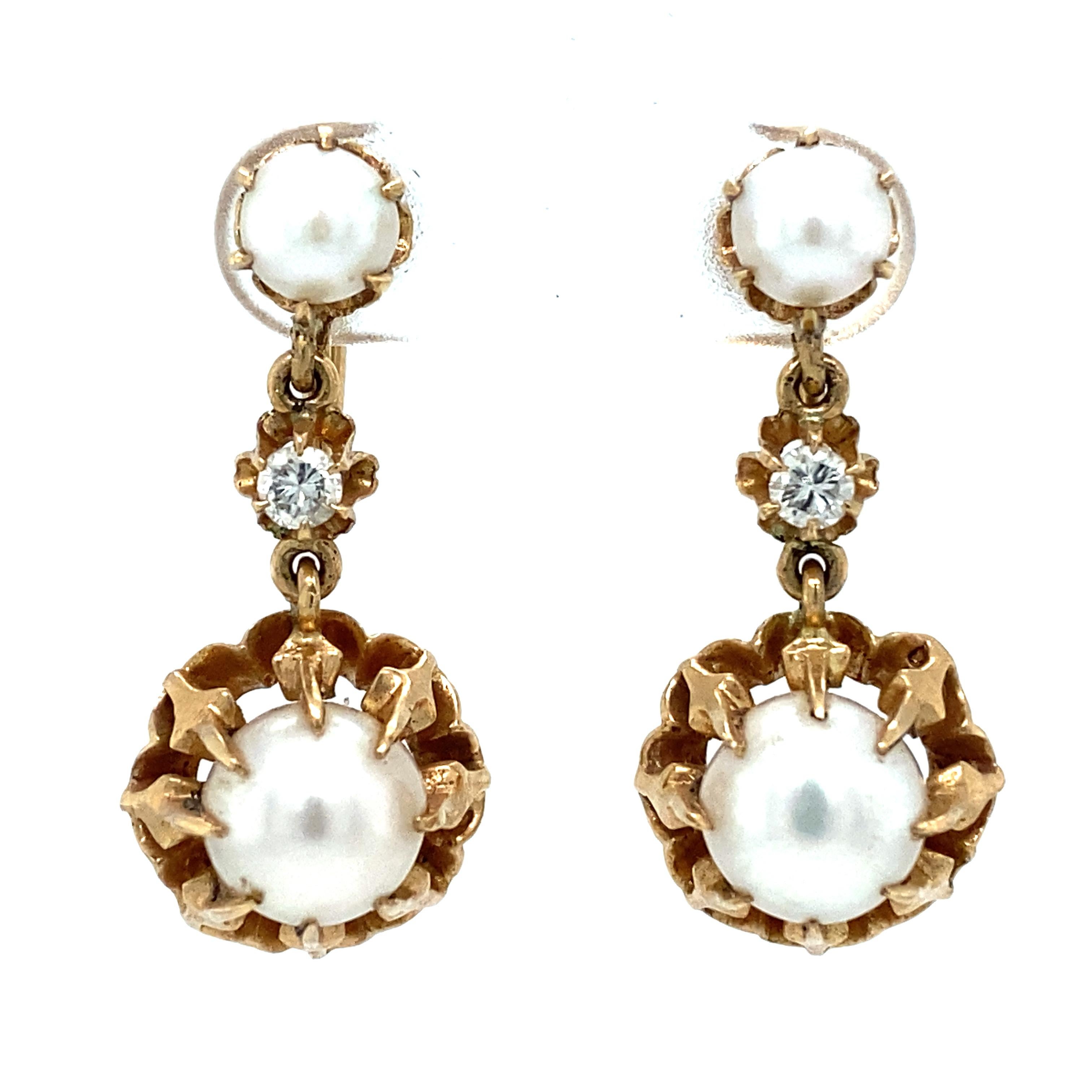 Item Details: These vintage dangle earrings have large white pearls and accent diamonds. They are non-pierced with a screw-back design.

Circa: 1950s
Metal Type: 14 Karat Yellow Gold
Weight: 8.2 grams
Size: 1 inch Length 