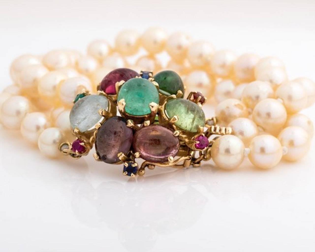 1950s Retro Pearl Bracelet - 14k Yellow Gold, Pearls, Tourmaline, Ruby, Sapphire & Emerald
These are freshwater, creamy white blister pearls. Blister pearls have a rougher texture but from a distance they appear to be smooth. 
The 14k yellow gold