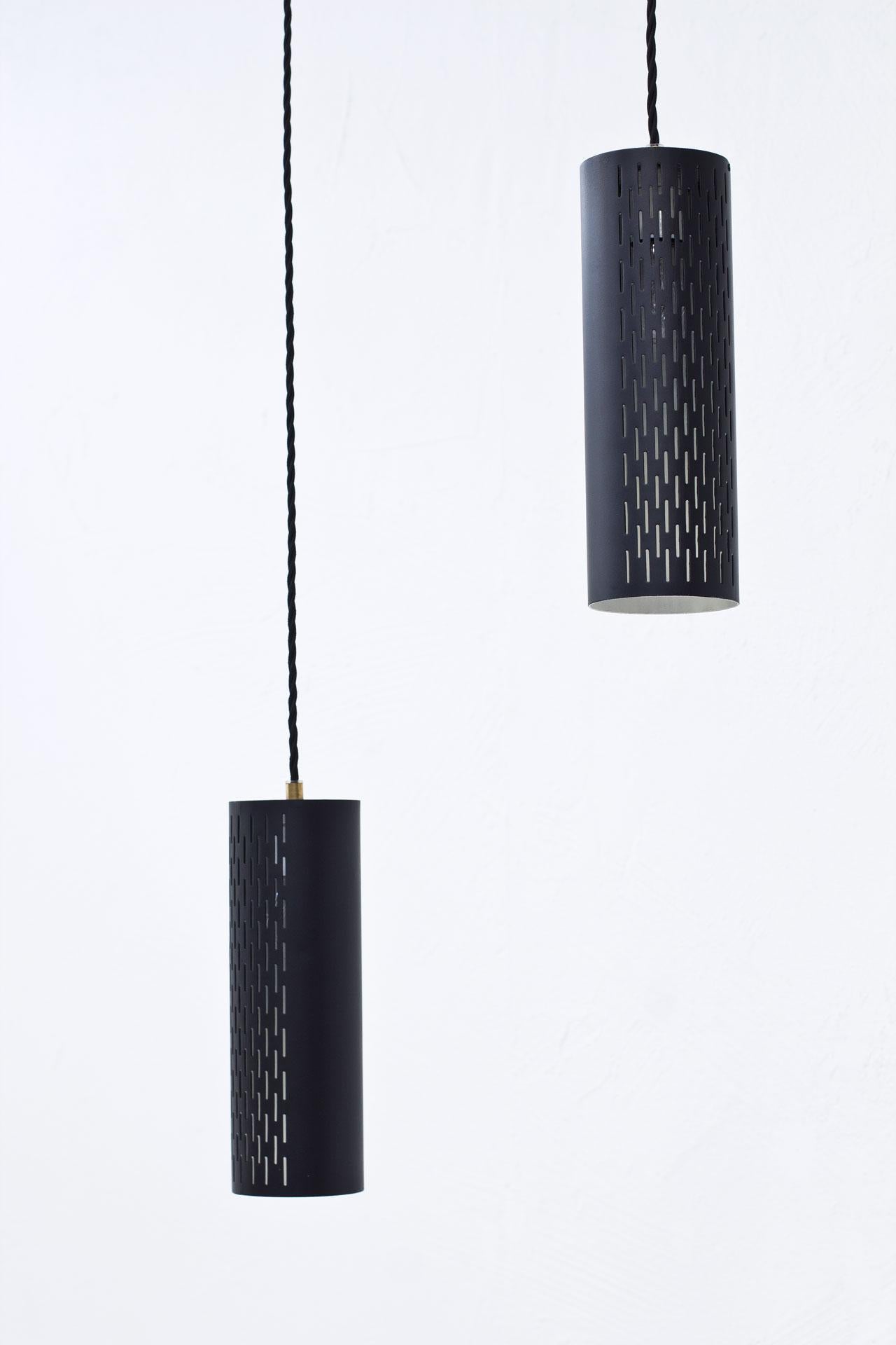 Neat pair of pendant lamps model 179 designed by Hans Bergström for Ateljé Lyktan.
Manufactured in Sweden during the 1950s.
Perforated black lacquered metal shades with brass fittings.
New electricity.