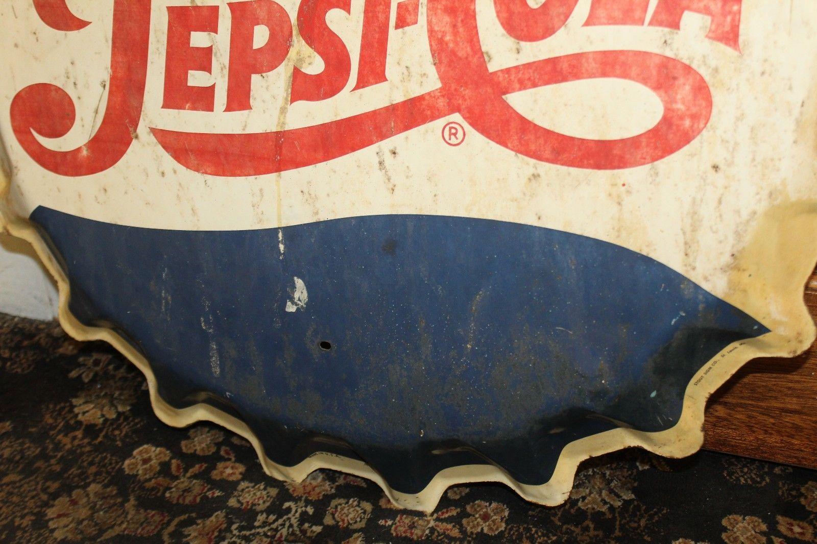 A Classic from the 1950s, a metal sign in the shape of a bottle top. Pepsi didn't produce as many advertising pieces compared to what Coca-Cola did.