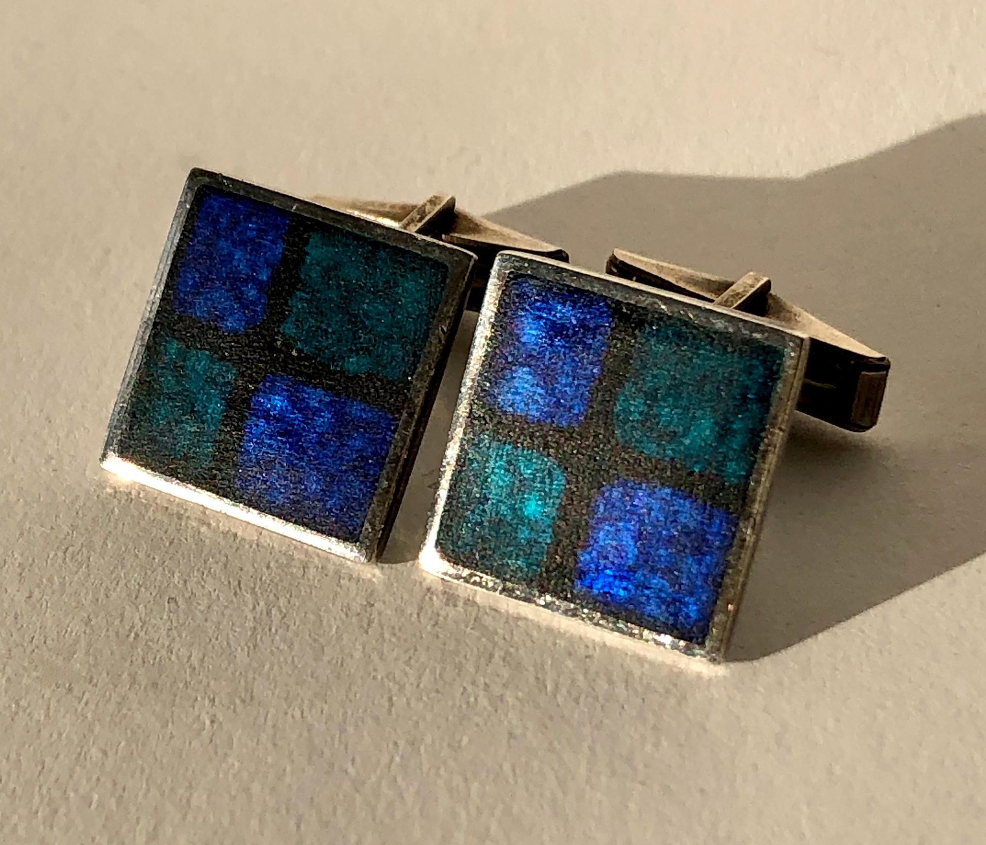 Pair of German modernist silver and enamel cufflinks designed by Perli, circa 1950s.  Dark blue grid cufflinks have counter enamel in black.  The measure about .75