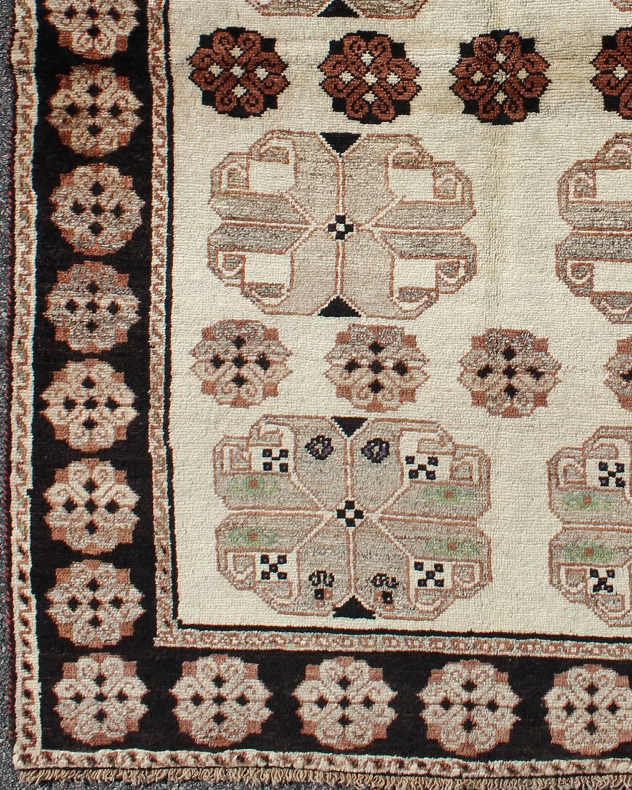1950s Persian Gabbeh vintage rug with blossom medallions in brown, ivory, onyx, rug h-1205-04, country of origin / type: Iran / Gabbeh, circa 1950

This high-pile mid-20th century vintage Persian Gabbeh carpet consists of repeating blossom