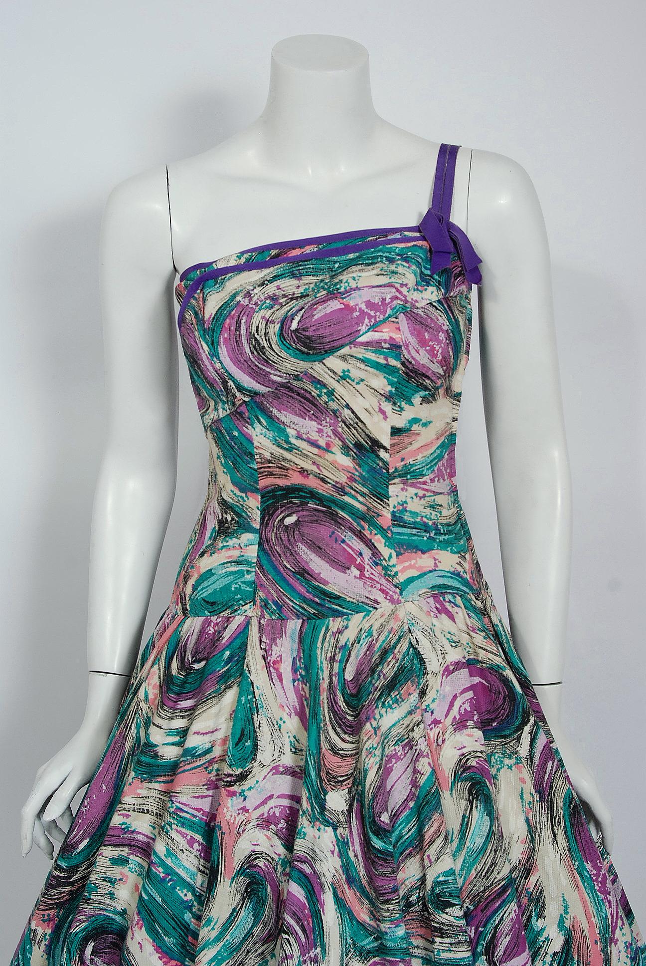 This Perullo for David Hart designer show-stopper is one of the most alluring and flattering 1950's print dresses I have ever seen. Fashioned from a luxurious purple, blue & creme abstract atomic splatter print cotton-pique, this creation has