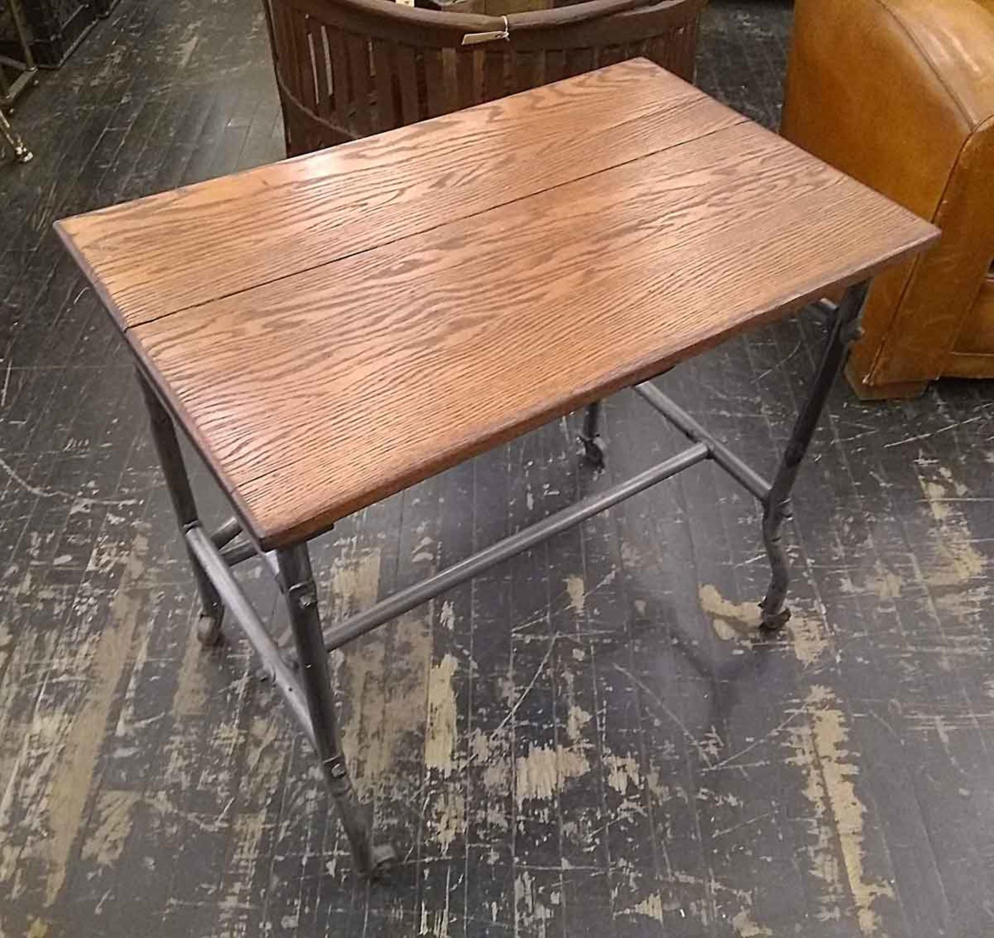 1950s industrial style rolling table with a medium wood tone oak top. Steel tube frame with wheels construction. This can be seen at our 1800 South Grand Ave location in Downtown Los Angeles.