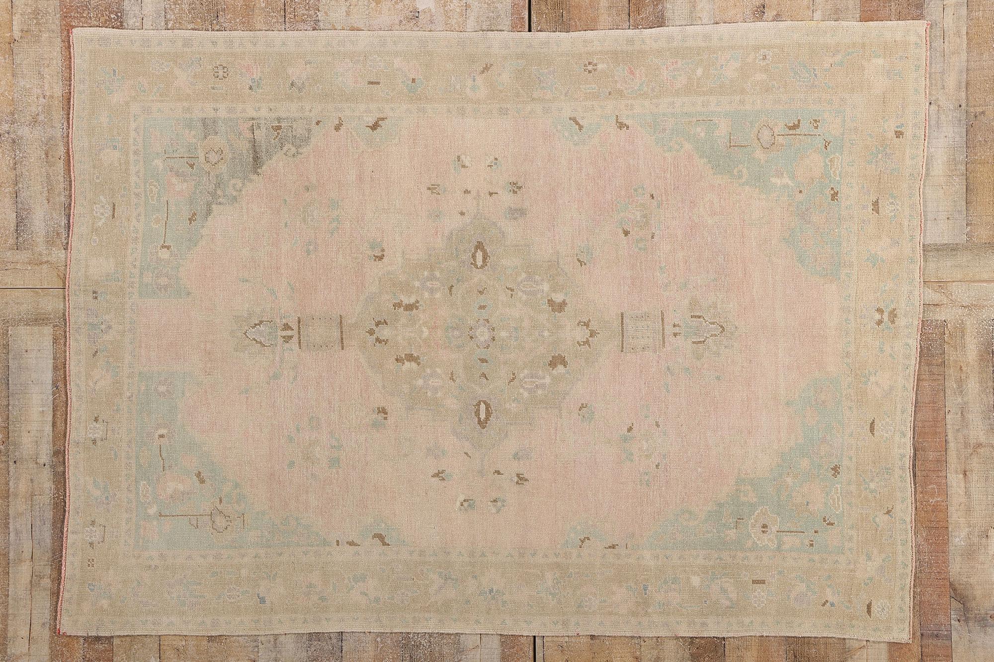 53995 Vintage Pink Turkish Oushak Rug, 05'06 x 07'08. Bathed in the tender hush of age and atmosphere, this hand knotted wool vintage Turkish Oushak rug evokes the soft lyricism of Anatolian grace. At its heart lies a taupe medallion, its shape