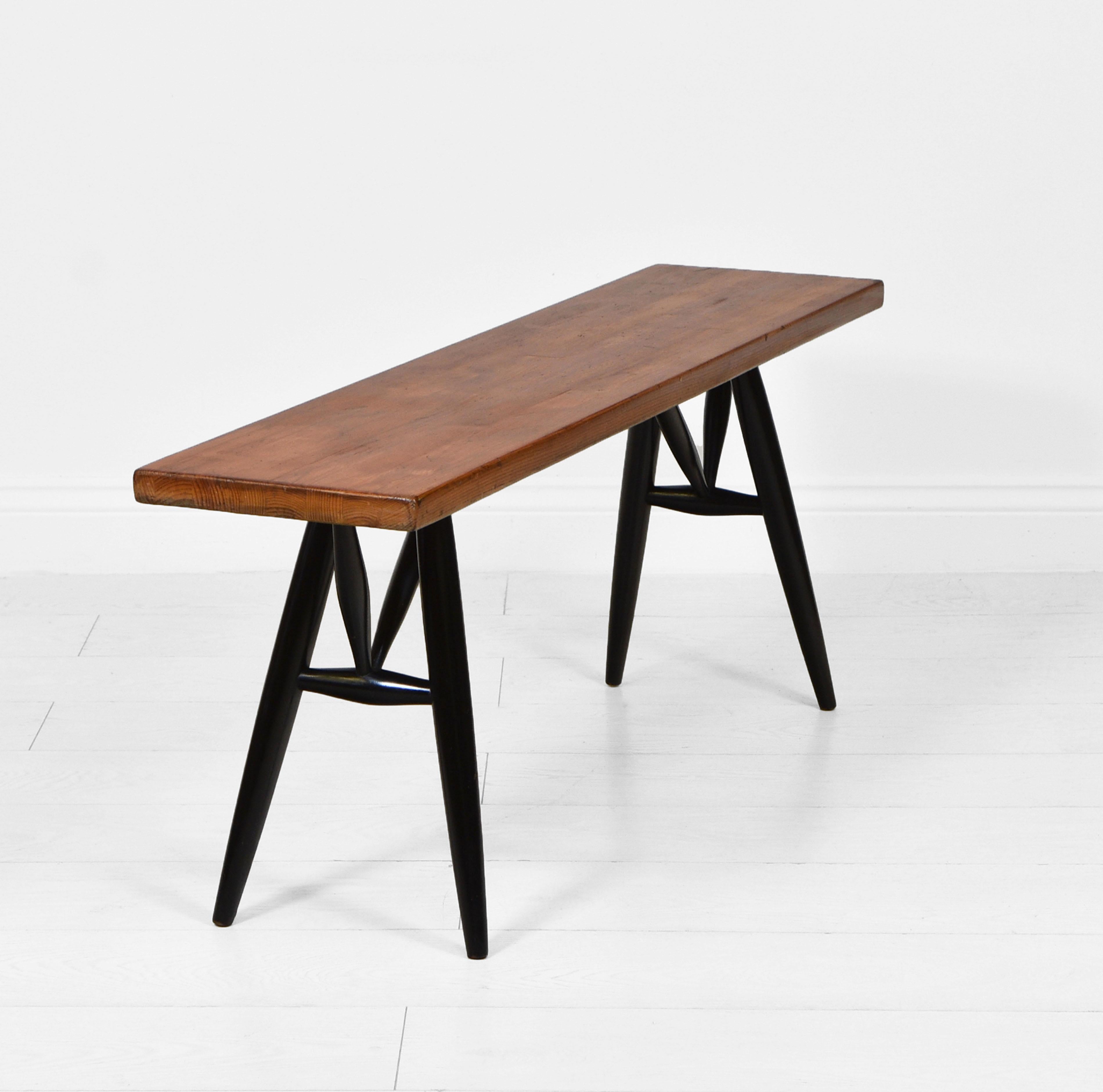 A small bench designed by Ilmari Tapiovaara for Laukaan Puu. Finnish. Circa 1950s. Maker's stamp.

The bench is very sturdy, with no damage, it has the original finish to the black lacquered wooden legs, which shows a small knock as shown,