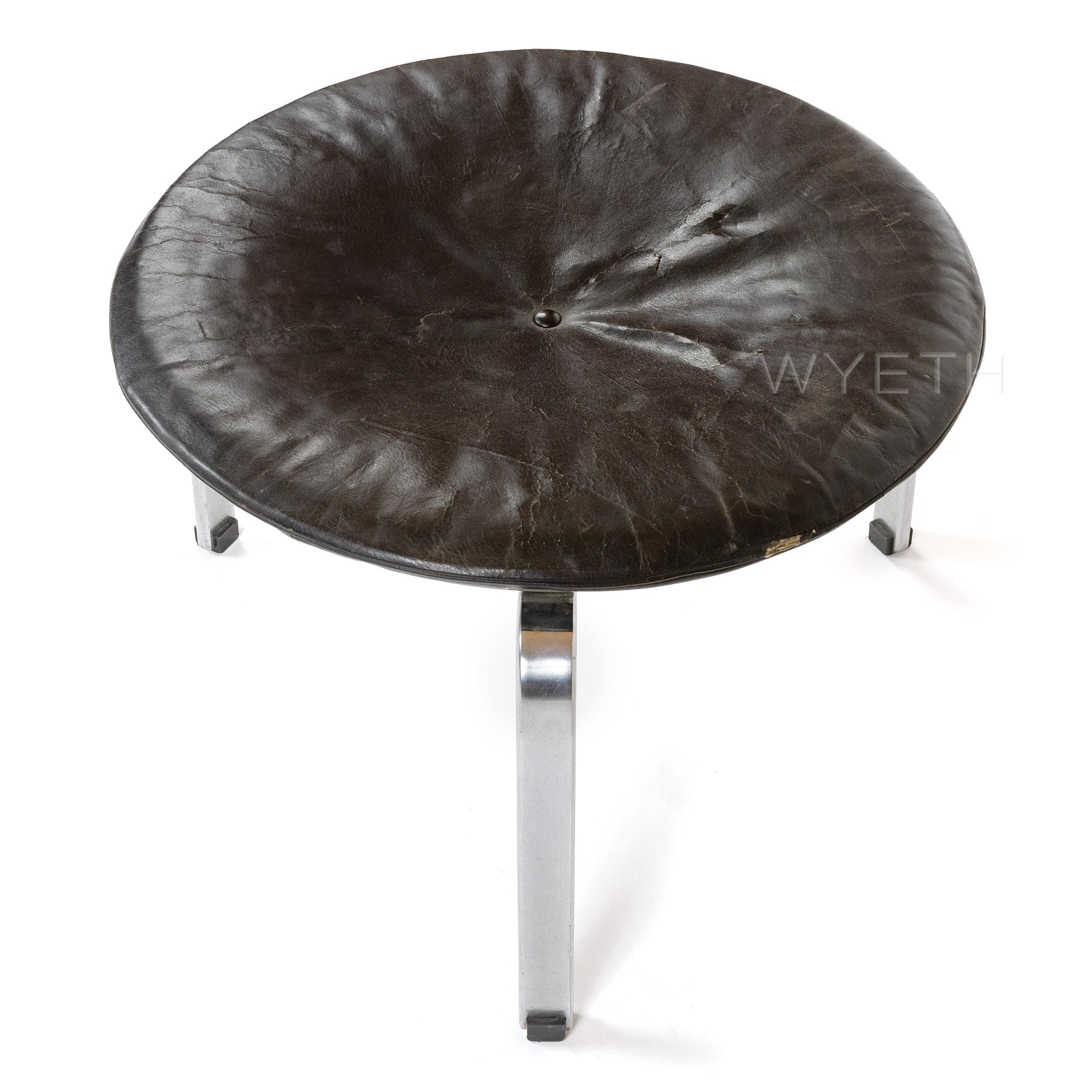 An early 'PK-33' stool, with a round black leather cushion on three satin-chromed flat bar legs. Maker's mark on underside.