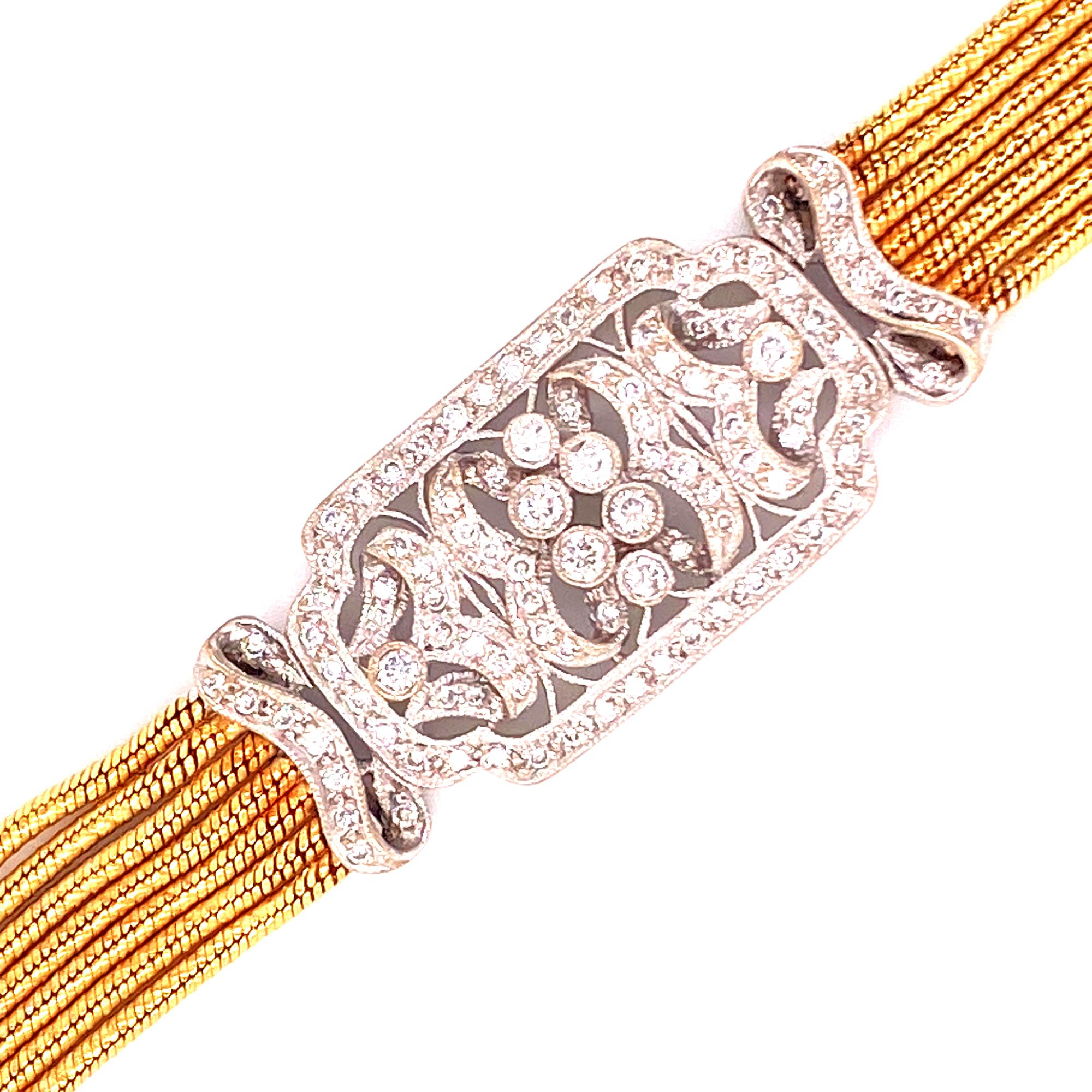 Fabulous 1950's platinum and 18 karat yellow gold bracelet. The diamond filigree top features 1.20 carat total weight of round brilliant cut diamonds graded G-H color and VS2-SI1 clarity. The beautifully hand crafted top is connected by a 7 row