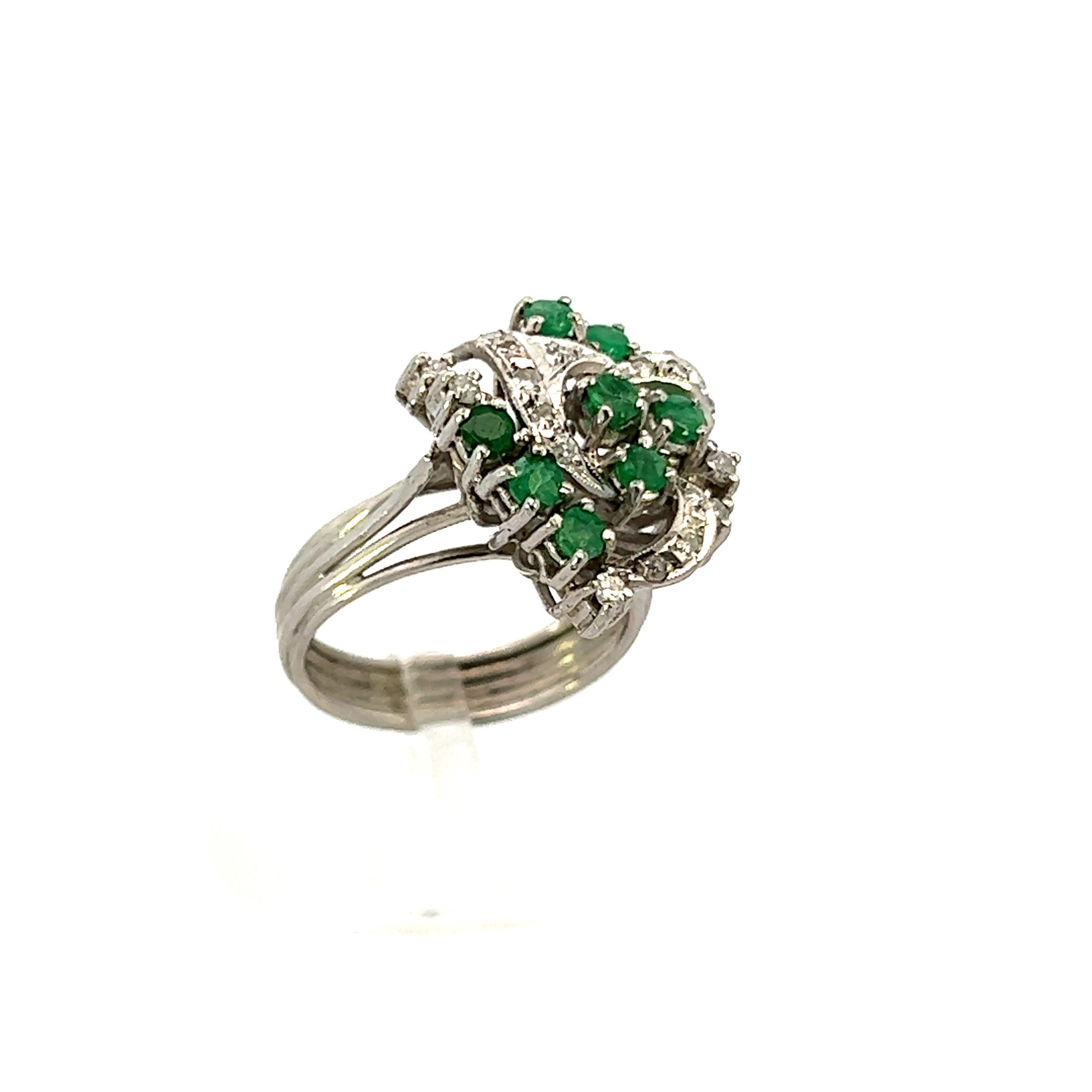 This 1950s platinum cocktail ring features emeralds with diamonds and is absolutely beautiful. The ring contains .25 cttw of G color VS1 clarity diamonds and .45 cttw of emerald, interconnected with platinum. Platinum, a forever white metal, is more