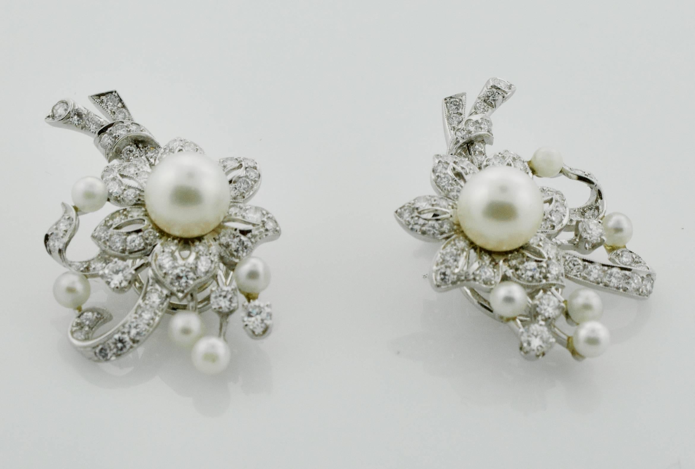 1950's Platinum Diamond and Pearl Handmade Earrings
Twelve Round Pearls Center Pearls 7.9 mm
One Hundred and Twenty Round Brilliant Cut Diamonds weighing 4.00 carats approximately GH VVS-VS
Beautifully Made by a Master Jeweler of The Day.  Clip