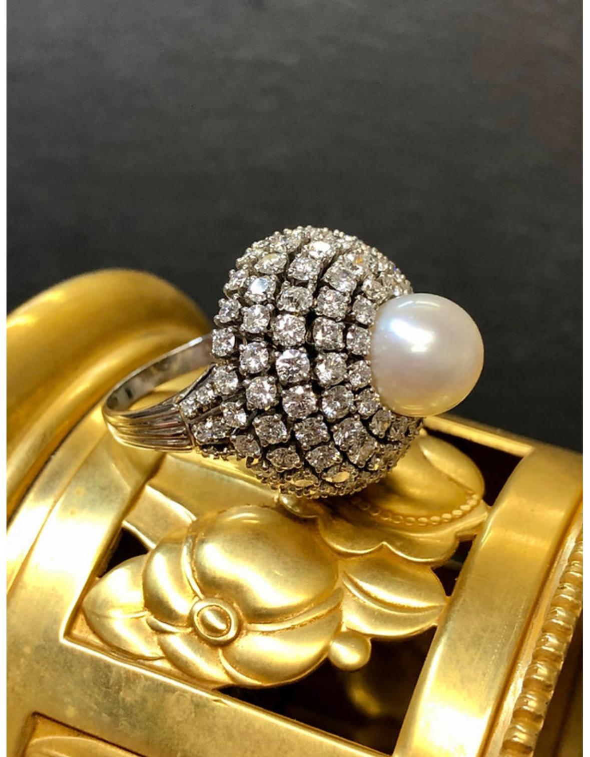 A knockout vintage 1950’s dome ring done in platinum and set with approximately 6.70cttw in G-J color Vs1-2 clarity round diamonds and centered by a 10mm Pearl.

Condition
All stones are secure and in very wearable condition.

Dimensions
.90” in