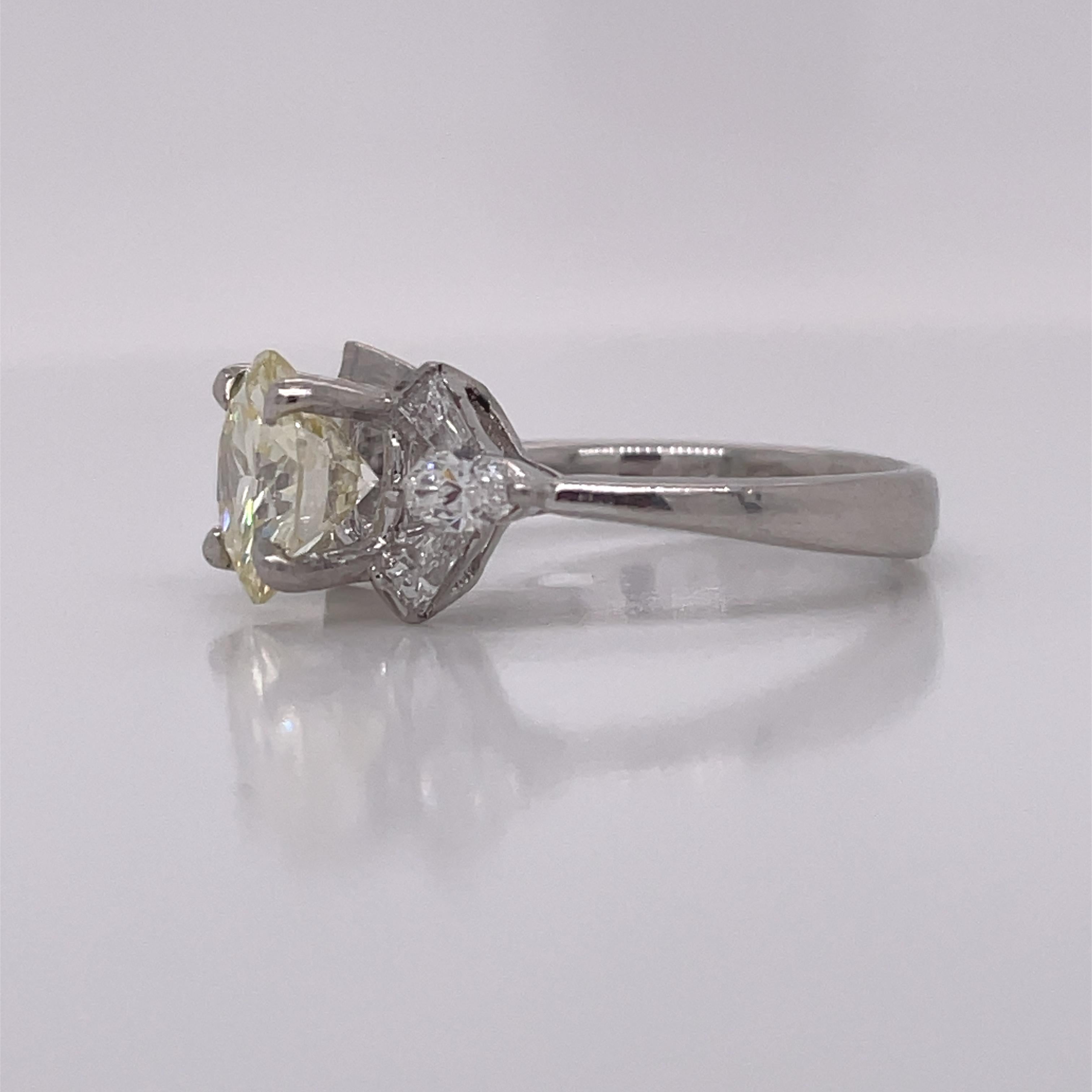 This is a lovely 1950s Platinum Diamond Ring featuring gorgeous tapered baguettes and marquise cut diamonds! It is hard not to fall in love with this stunning ring! From her gorgeous 1.75ct center down to her gorgeous marquise and tapered baguettes